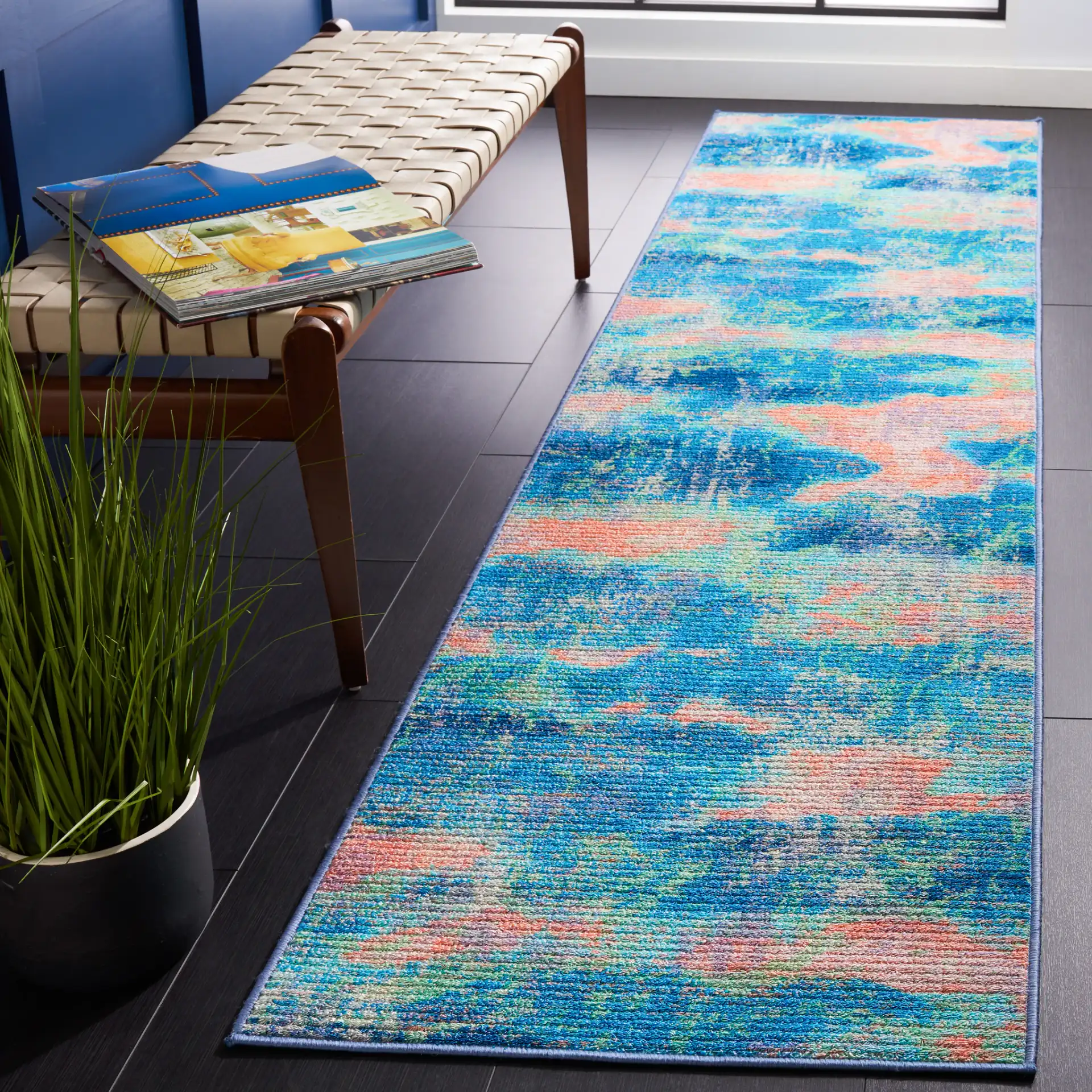 Sequoia Cloud Abstract Washable Rug in Blue / Orange in a styled room