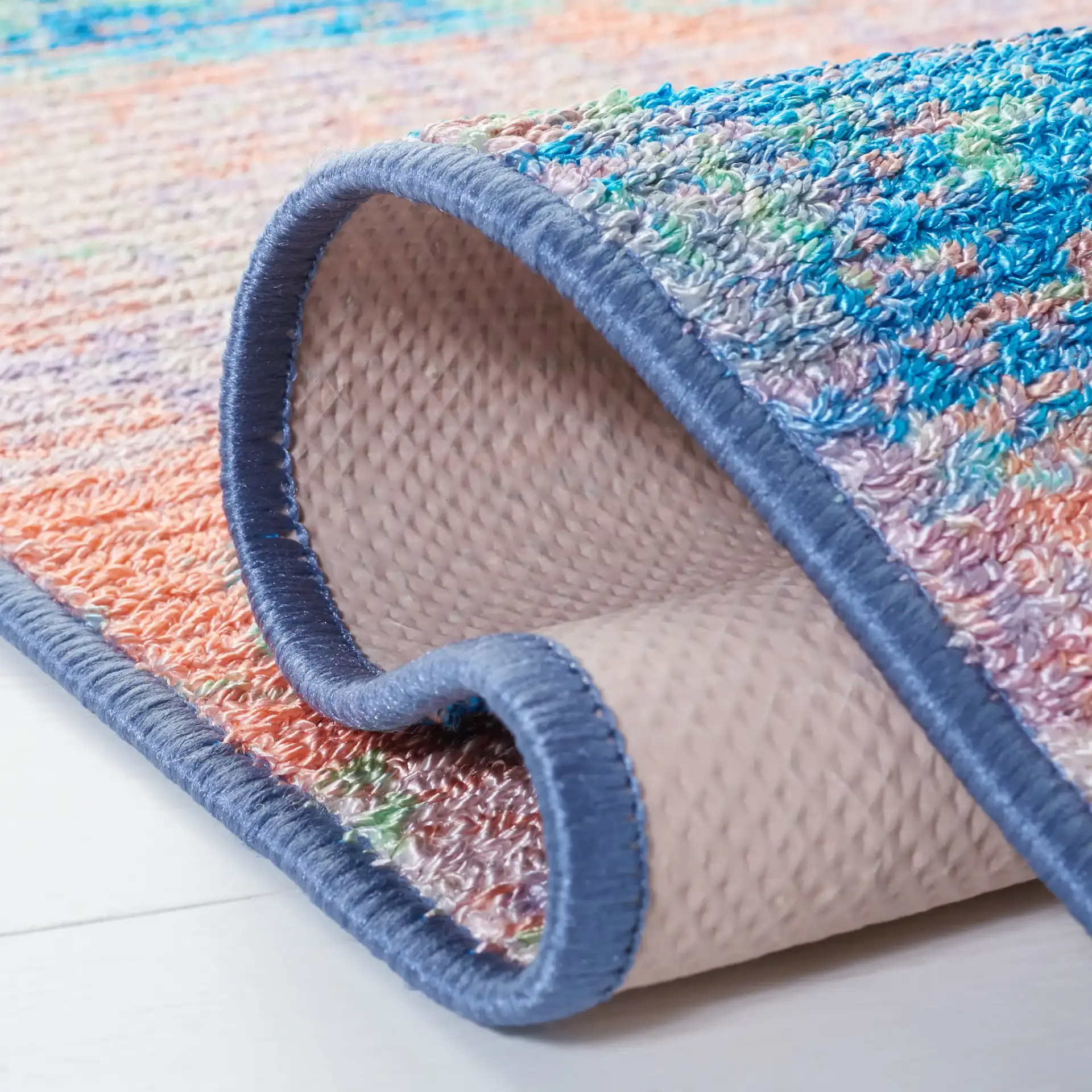 Sequoia Cloud Abstract Washable Rug in Blue / Orange in a styled room