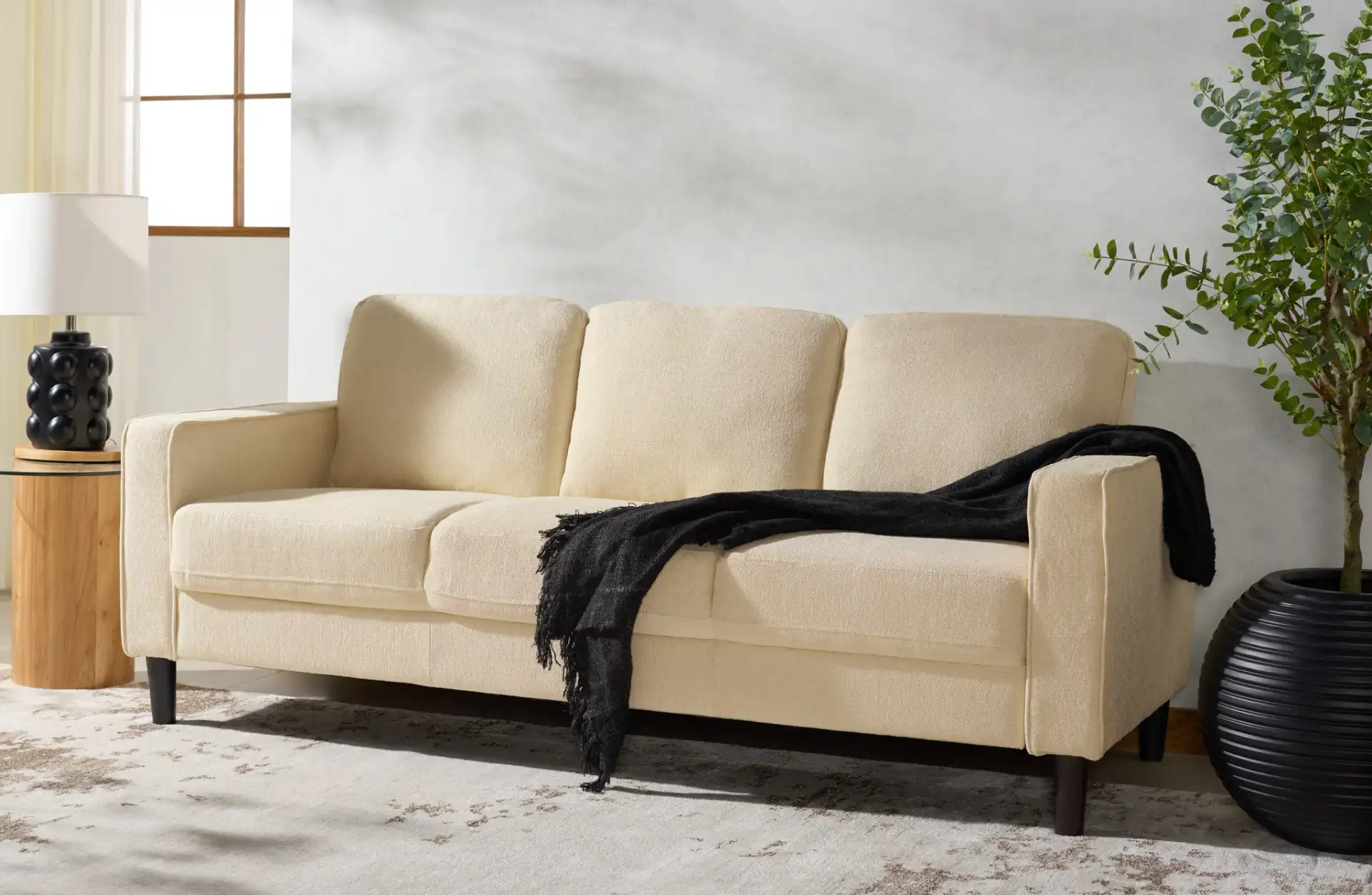 Felicianya Modern Three-Seater Sofa in Light Gray in a styled room