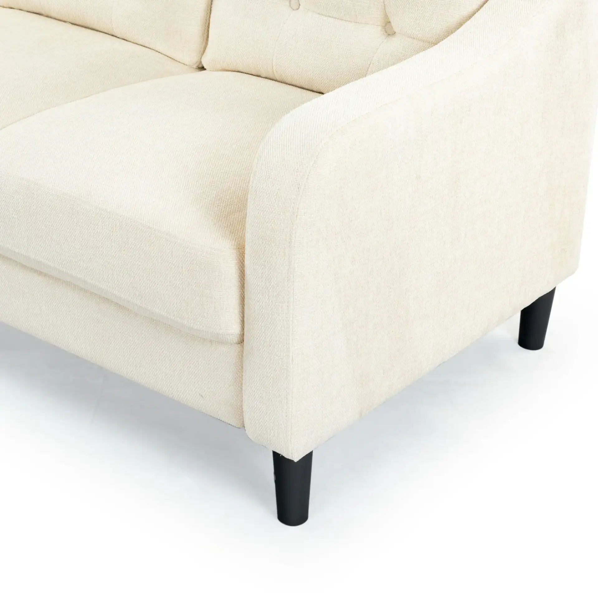 Nathaniel Tufted Three-Seater Sofa in Cream in a styled room