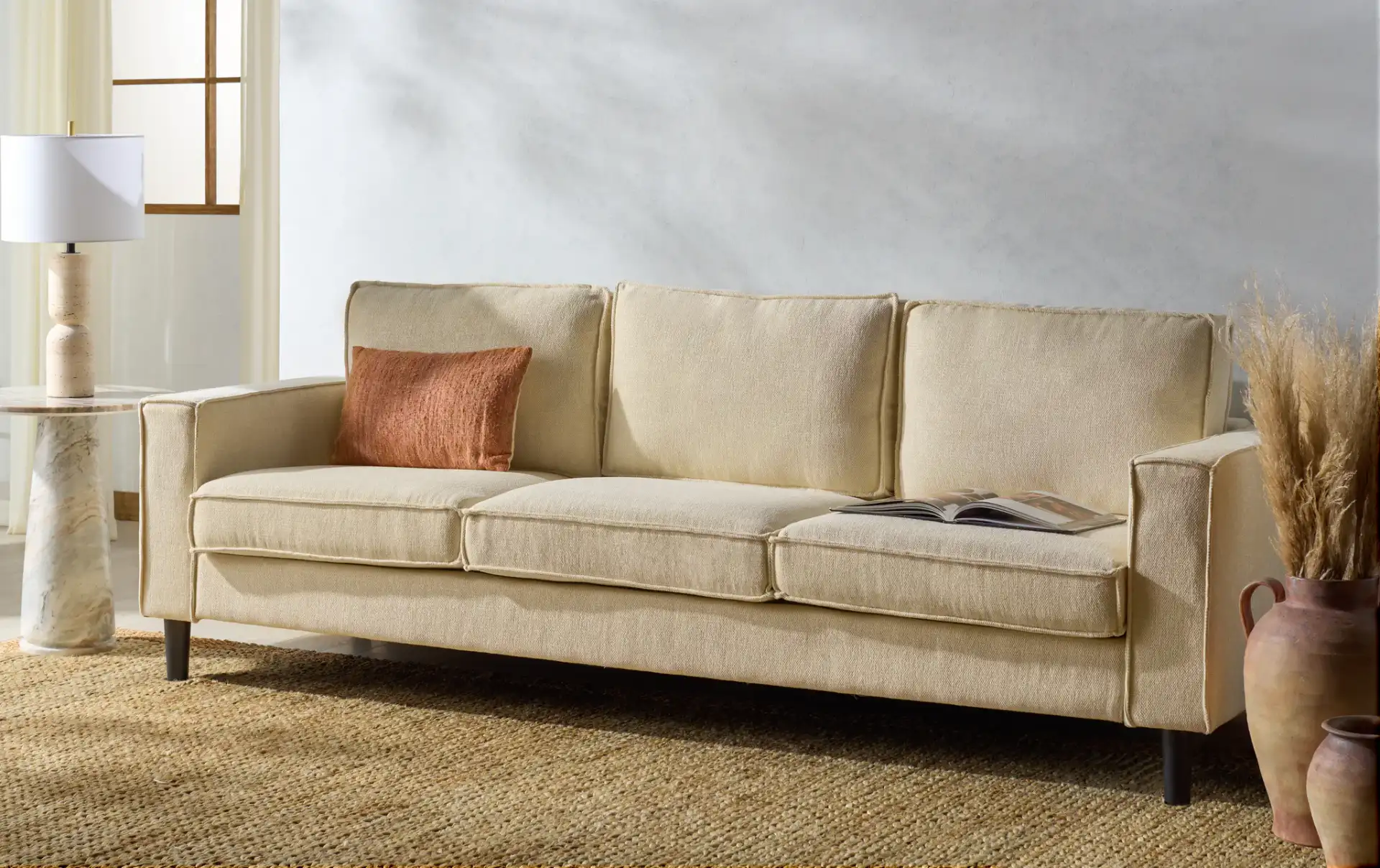 Kalyna Three-Seater Sofa in Cream in a styled room
