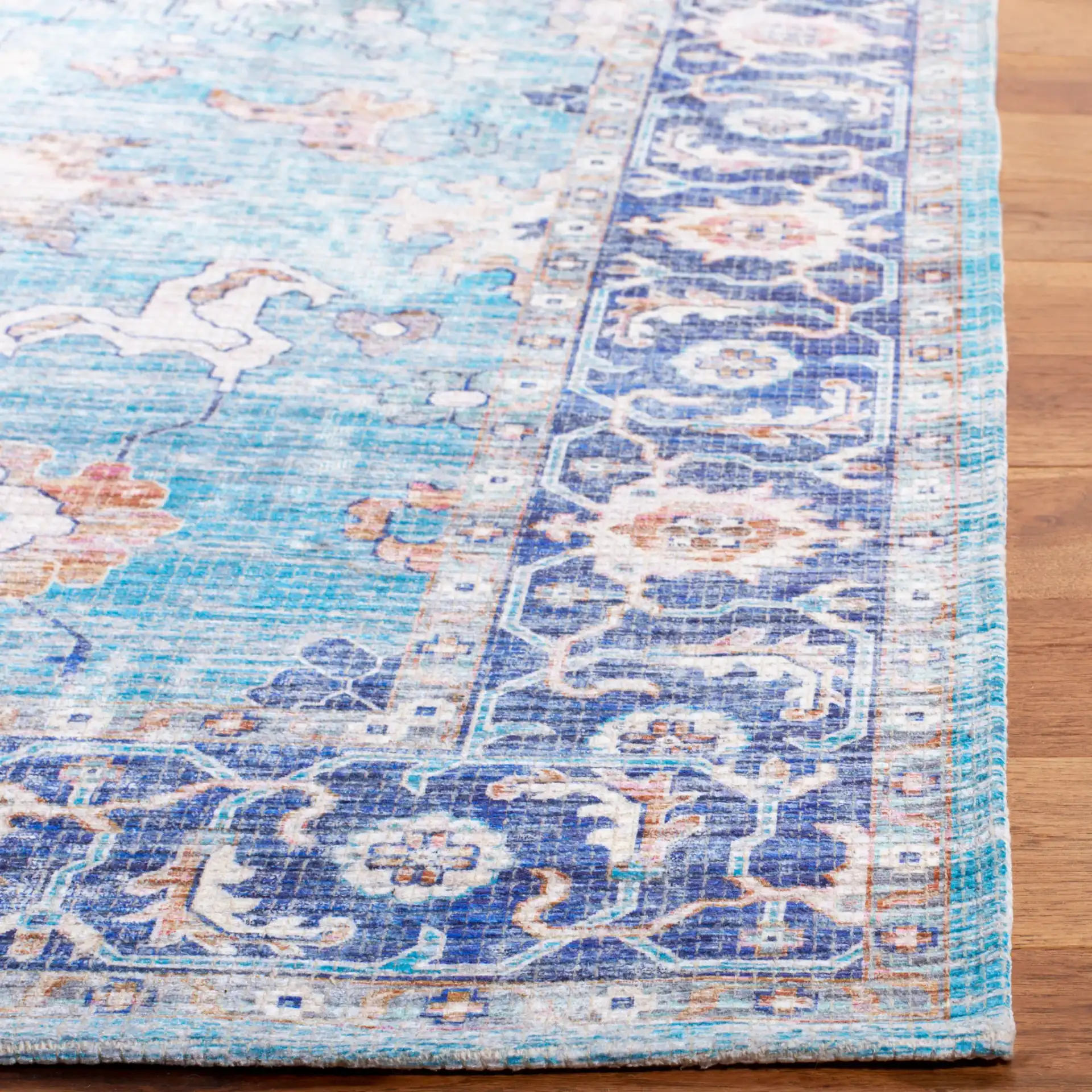 Saffron Medallion Bordered Rug in Aqua / Navy in a styled room