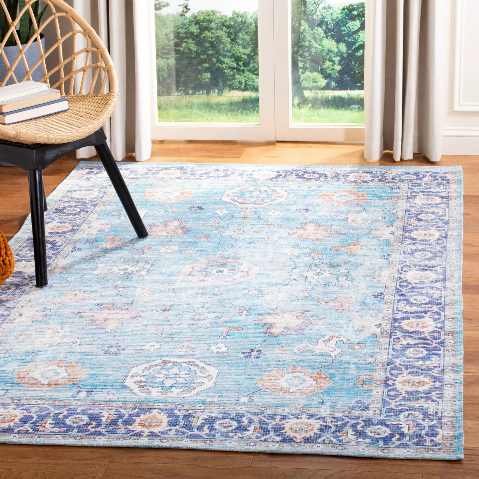 Saffron Medallion Bordered Rug in Aqua / Navy in a styled room