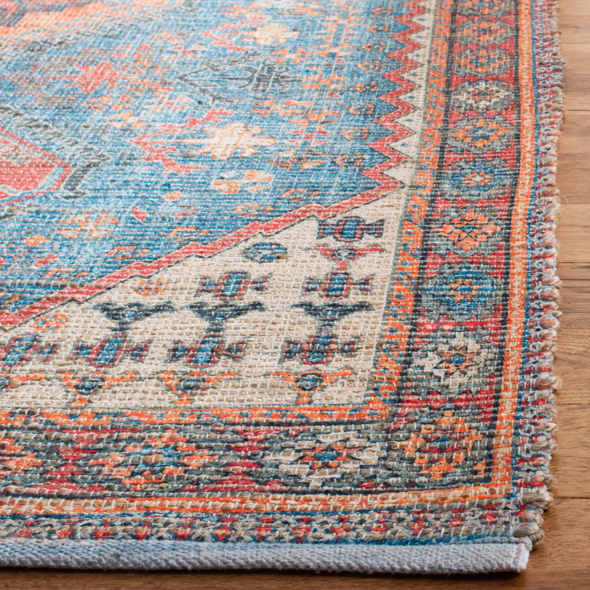 Saffron Tribal Triple Medallion Hand-Loomed Rug in Navy / Red in a styled room