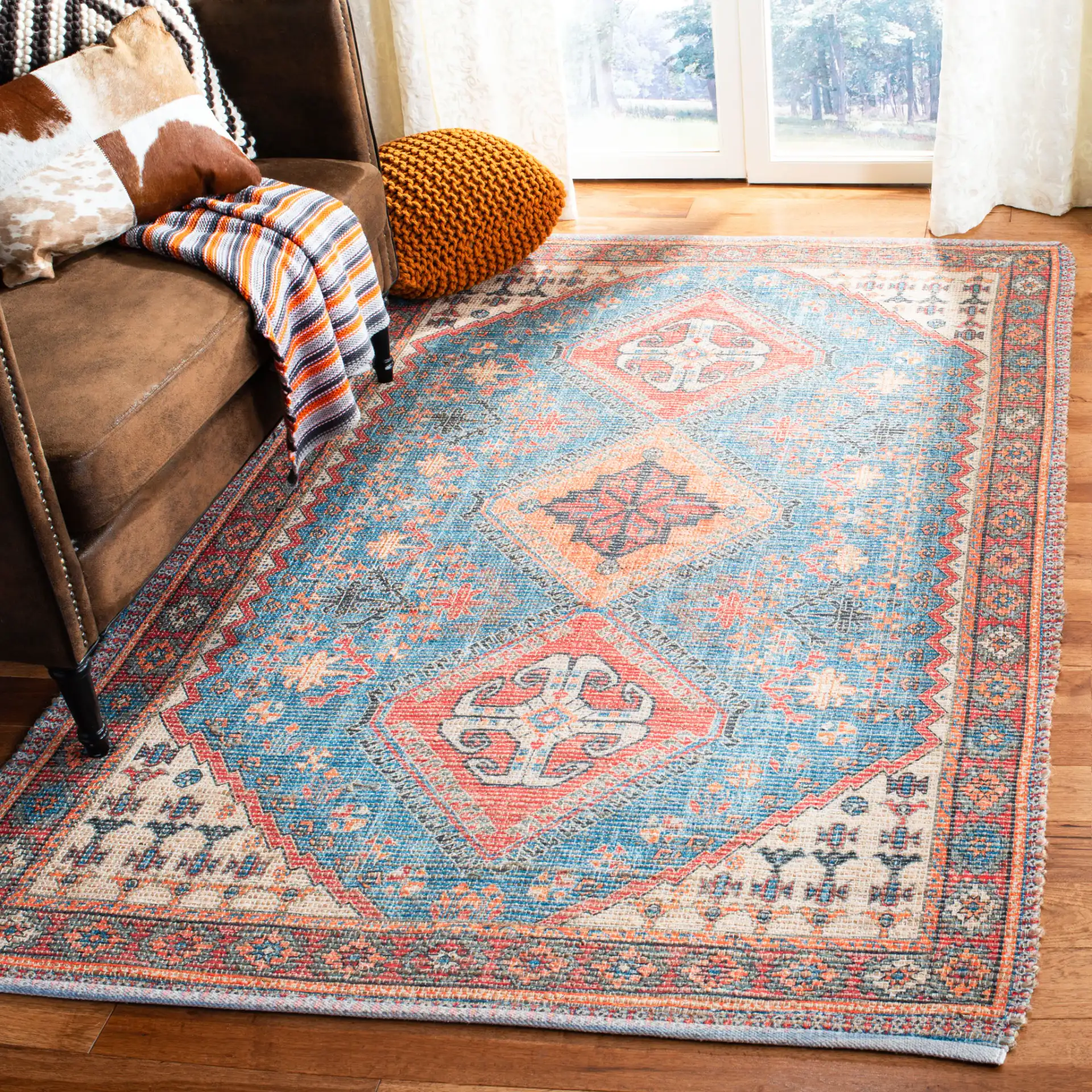 Saffron Tribal Triple Medallion Hand-Loomed Rug in Navy / Red in a styled room