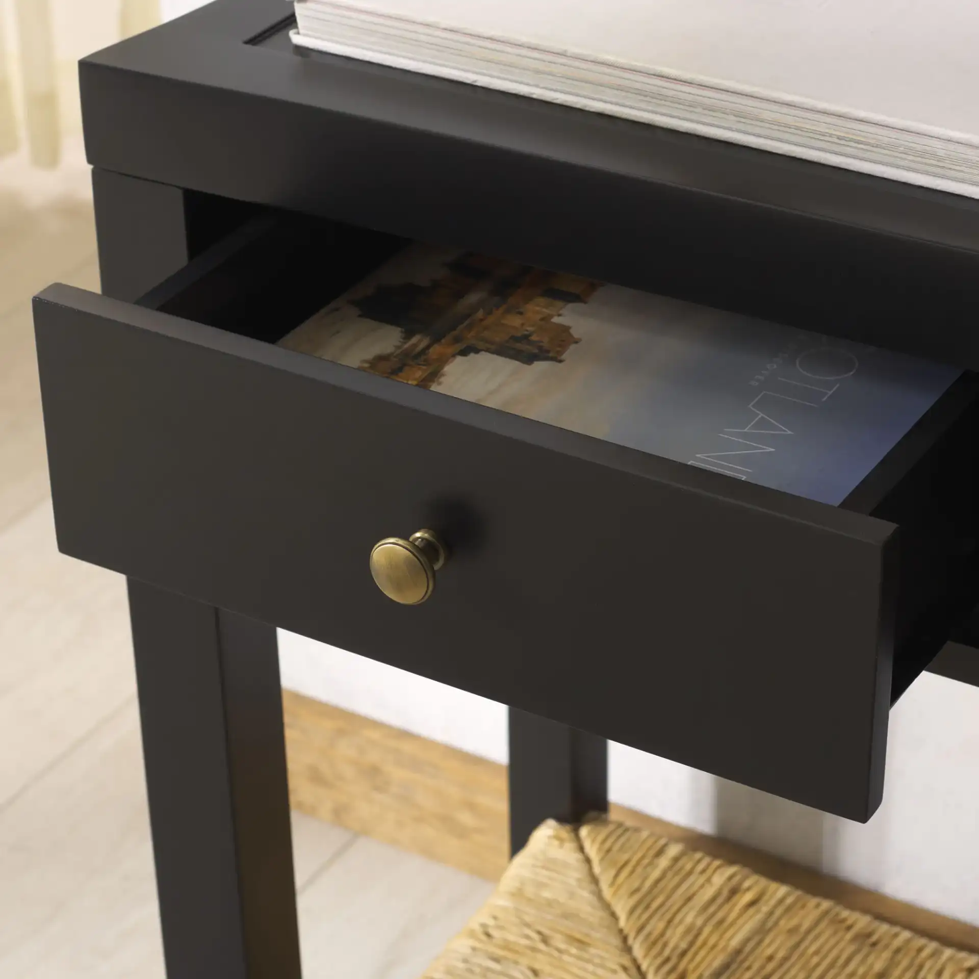 Berlynne Banana Console Table in Black / Natural in a styled room