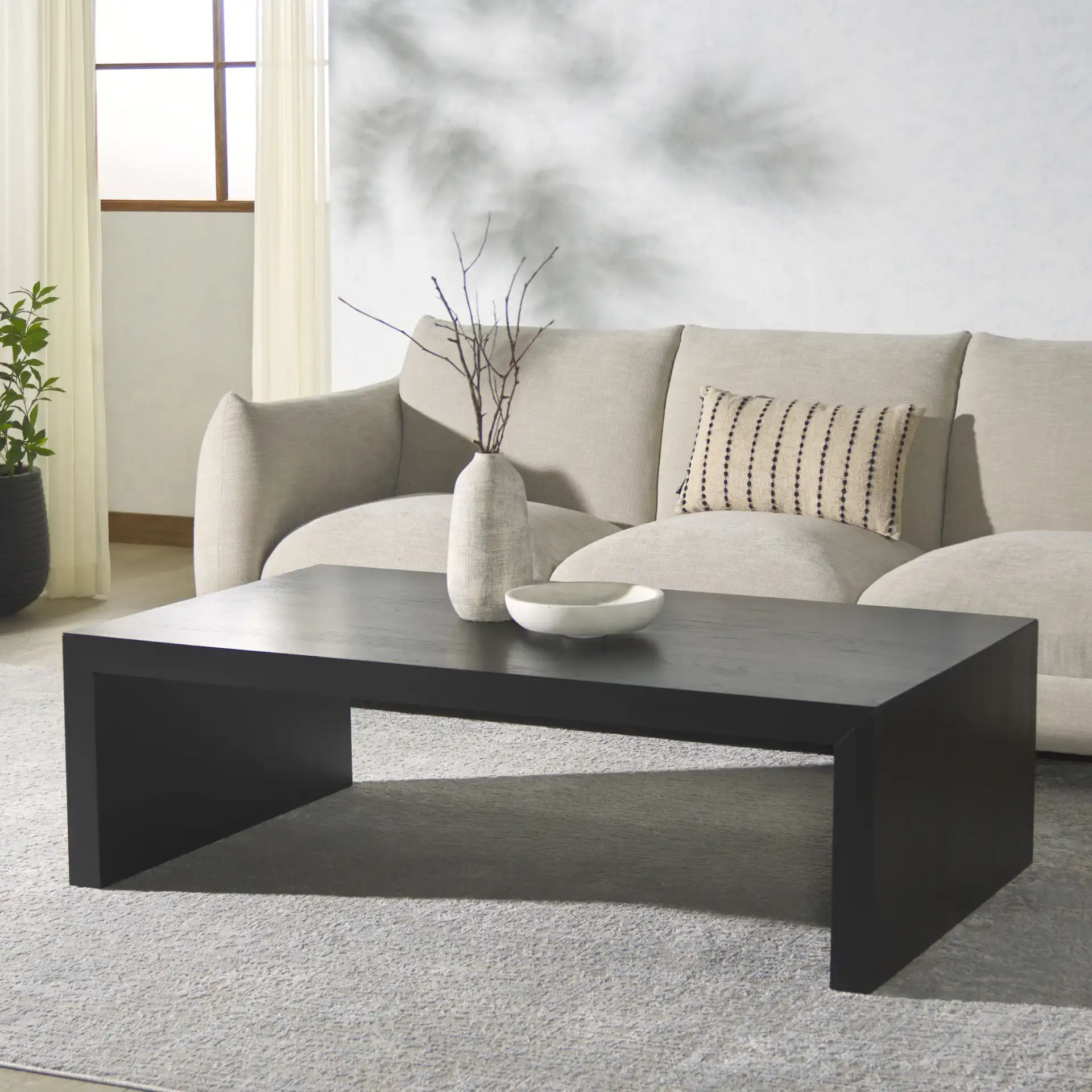 Tawney Rectangular Wood Coffee Table in Natural in a styled room