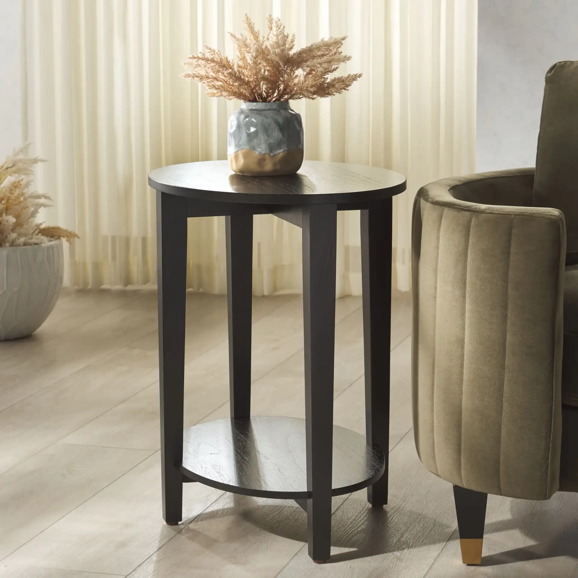 Leonardi Oval Wood Accent Table in Black in a styled room