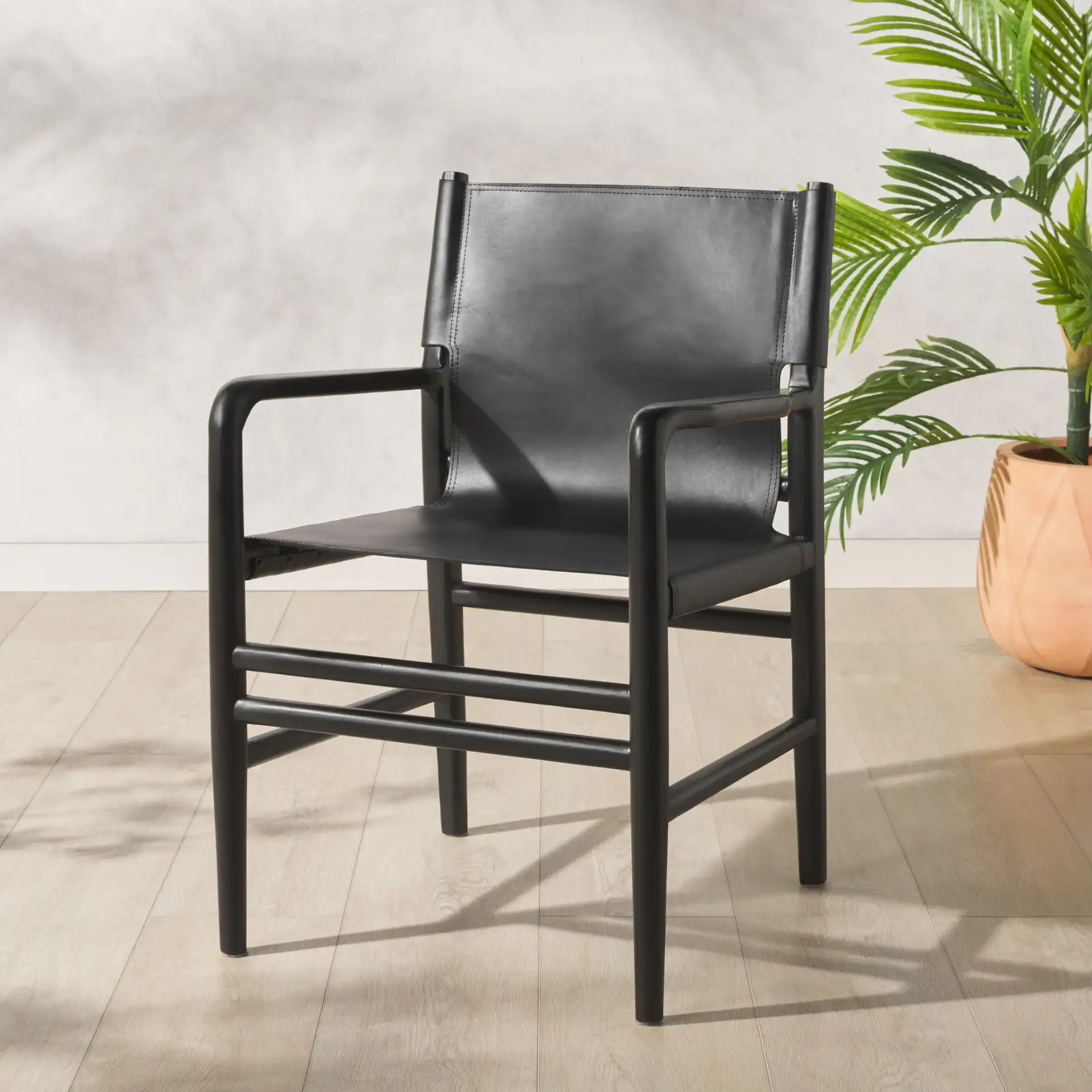 Cassaphina Leather Arm Chair in Black in a styled room