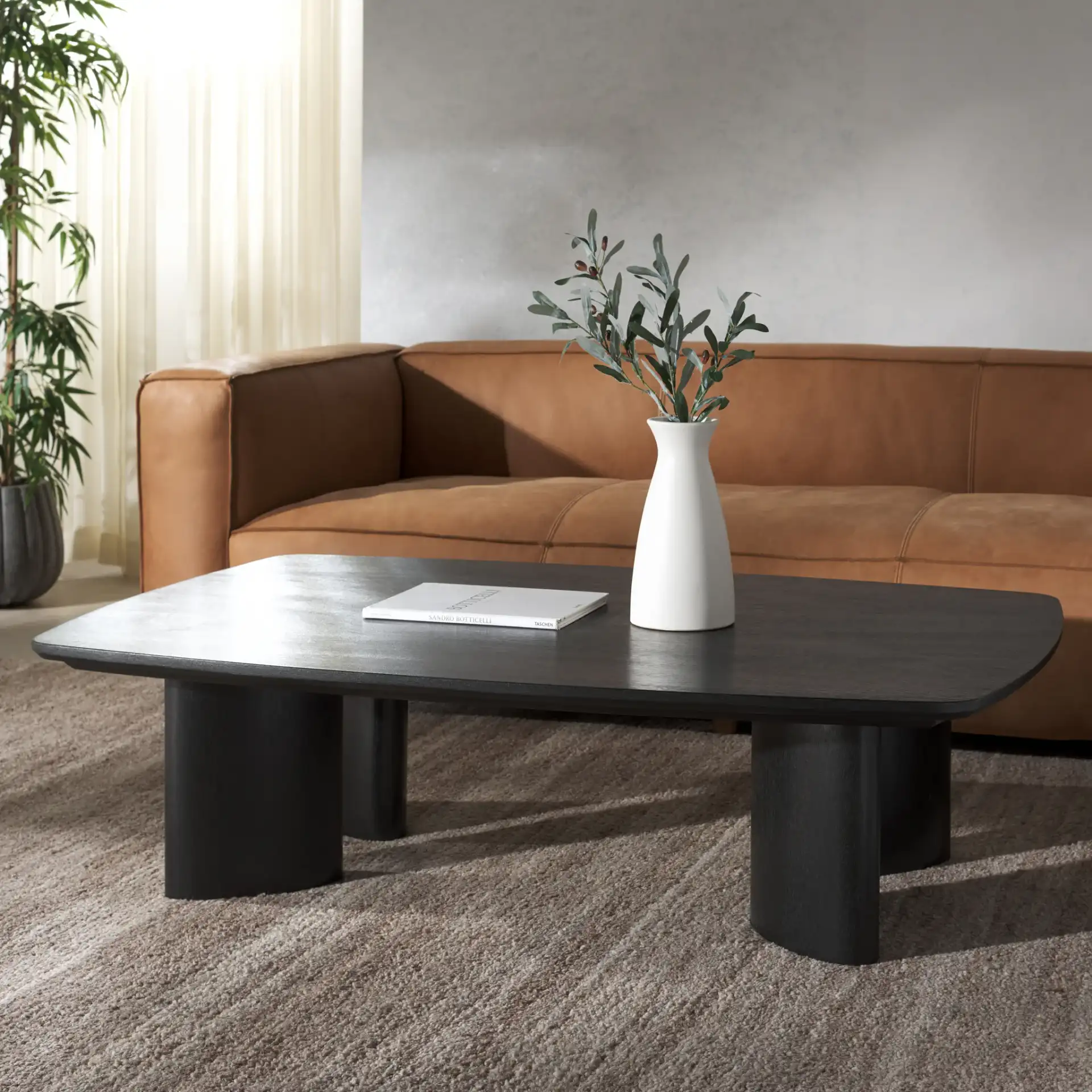 Barnard Rectangle Wood Coffee Table in Black in a styled room