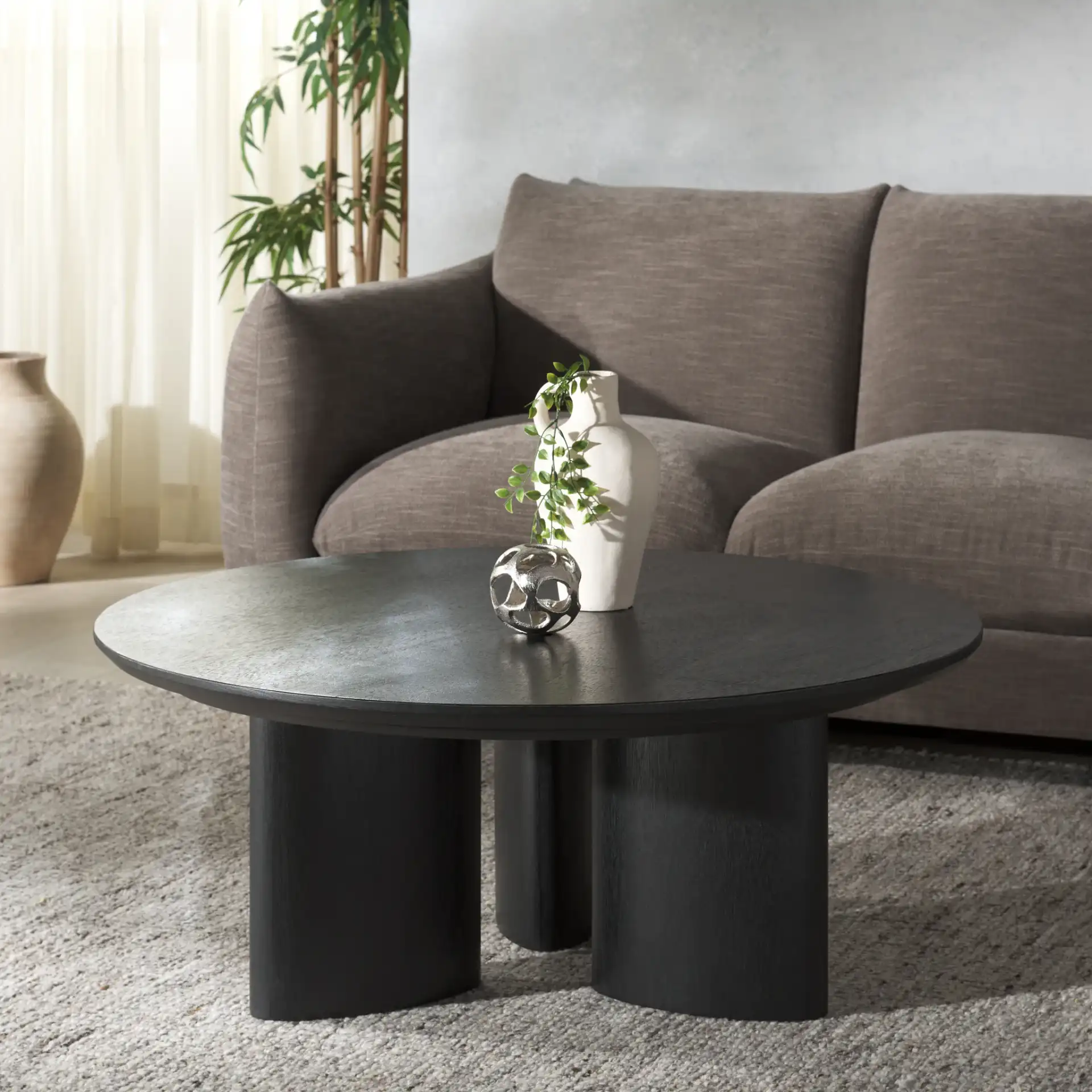 Barnard Round Wood Coffee Table in Black in a styled room