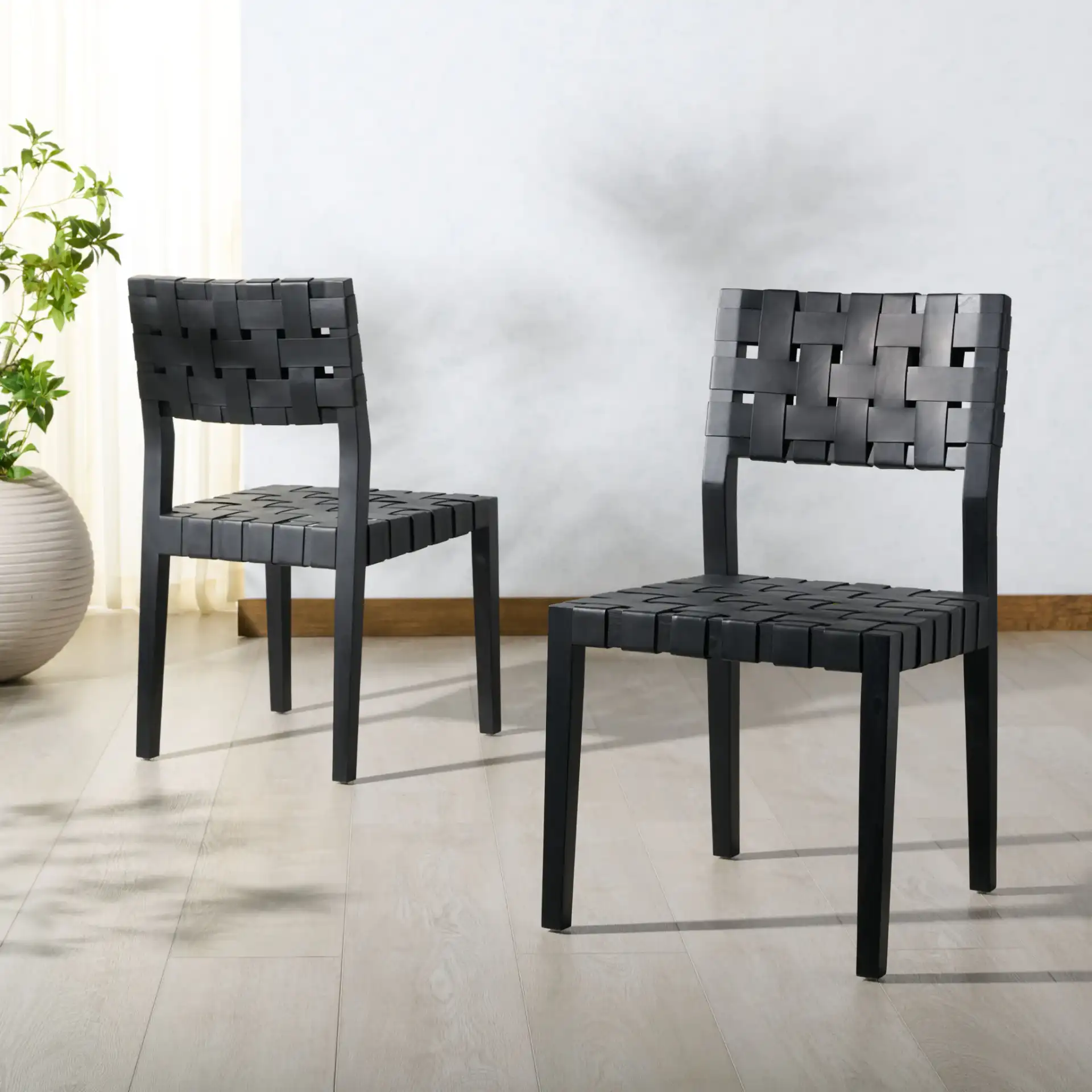 Bette Woven Leather Dining Chair (Set of 2) in Black in a styled room