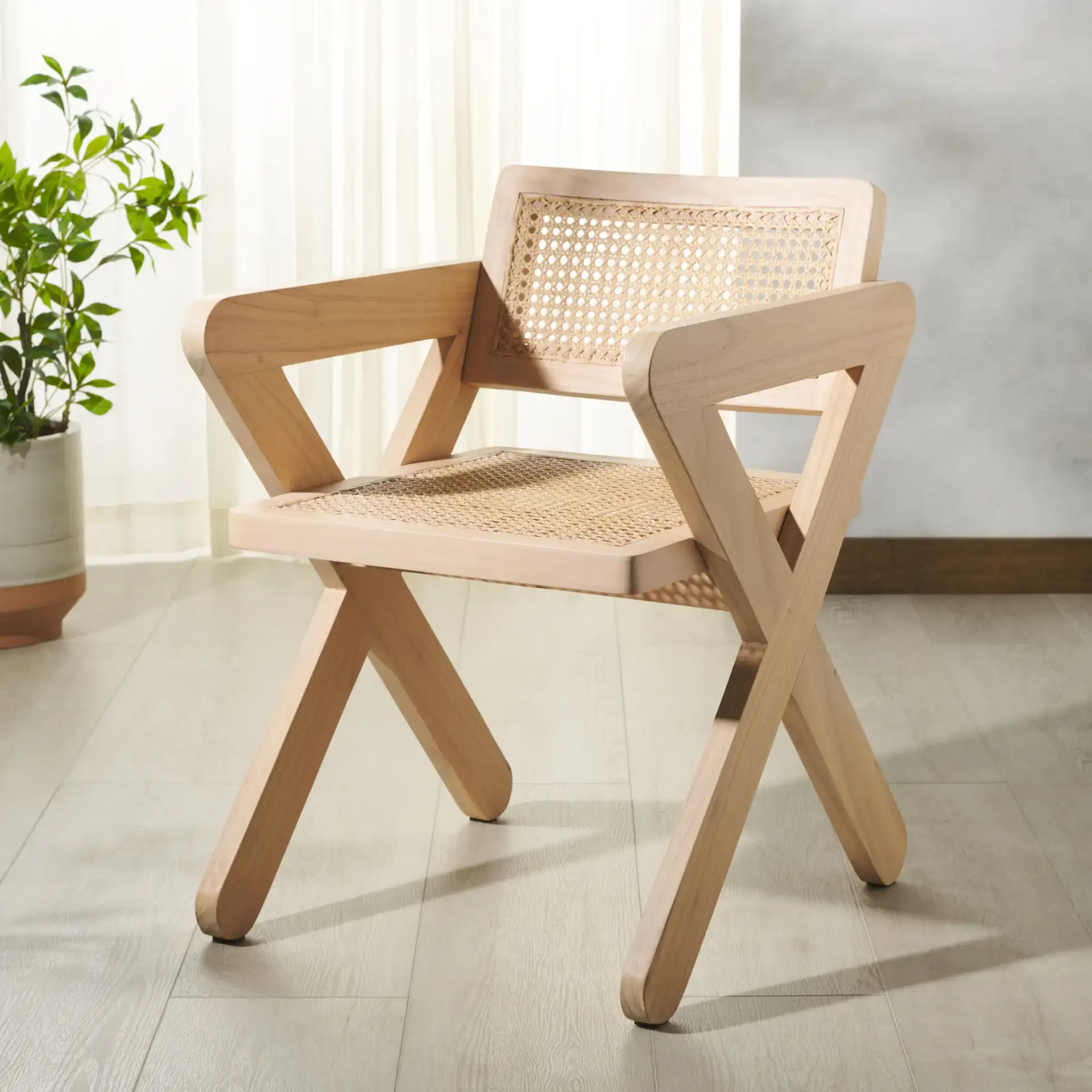 Tyrrell Rattan Dining Chair in Natural in a styled room