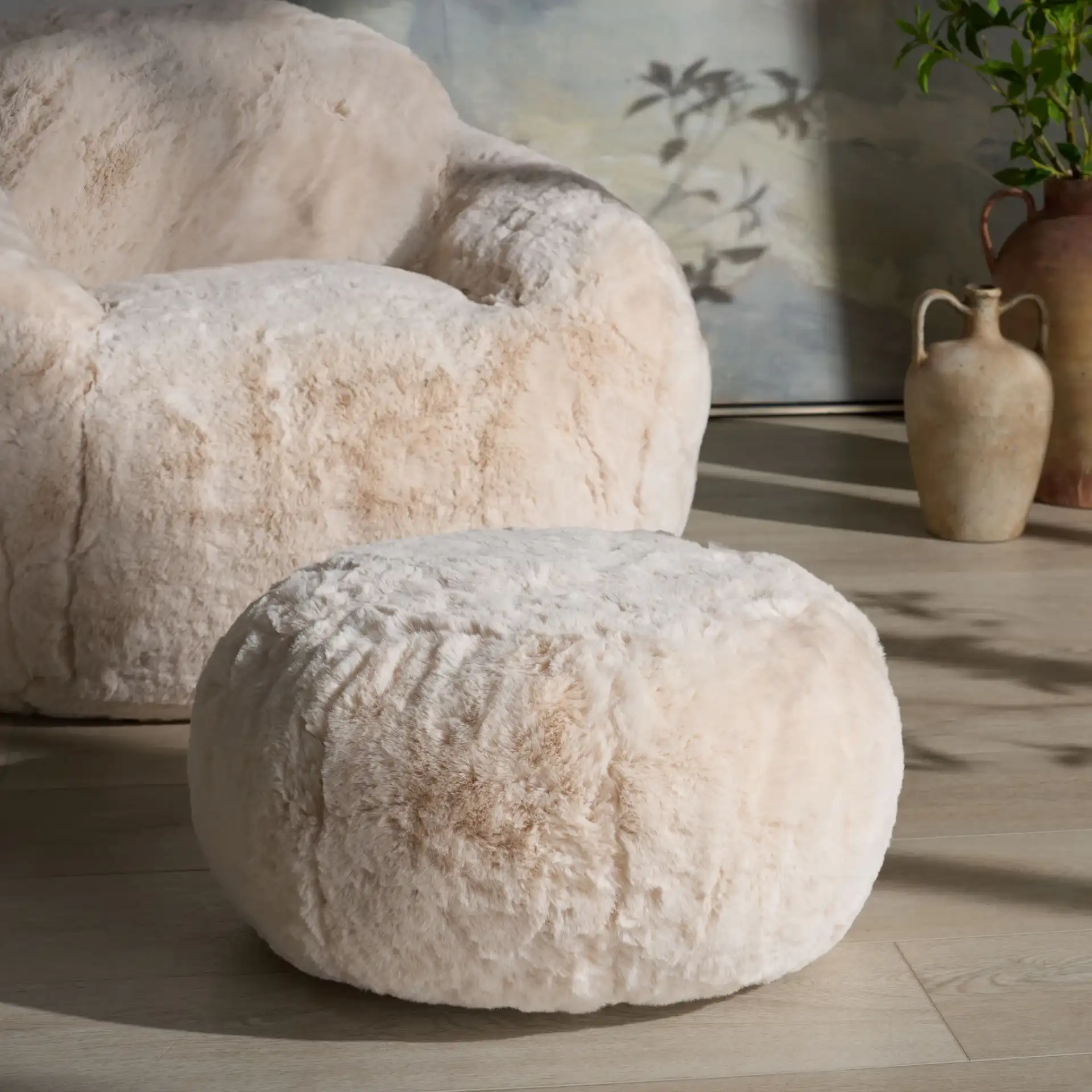 Gracelina Round Pouf in Cream in a styled room