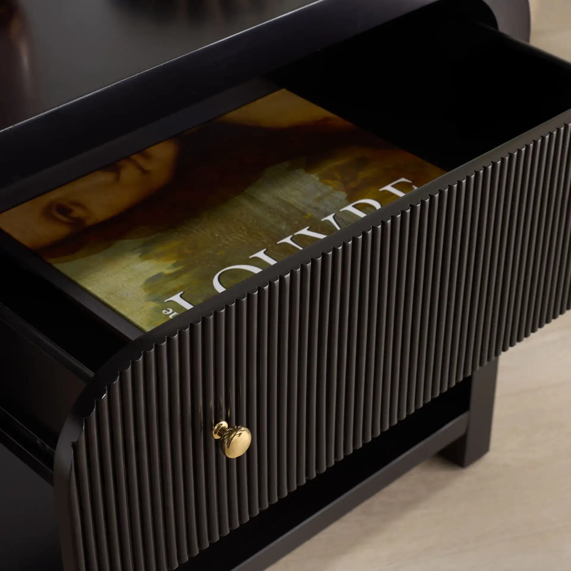 Liabella One-Drawer Curved Nightstand in Black / Gold in a styled room