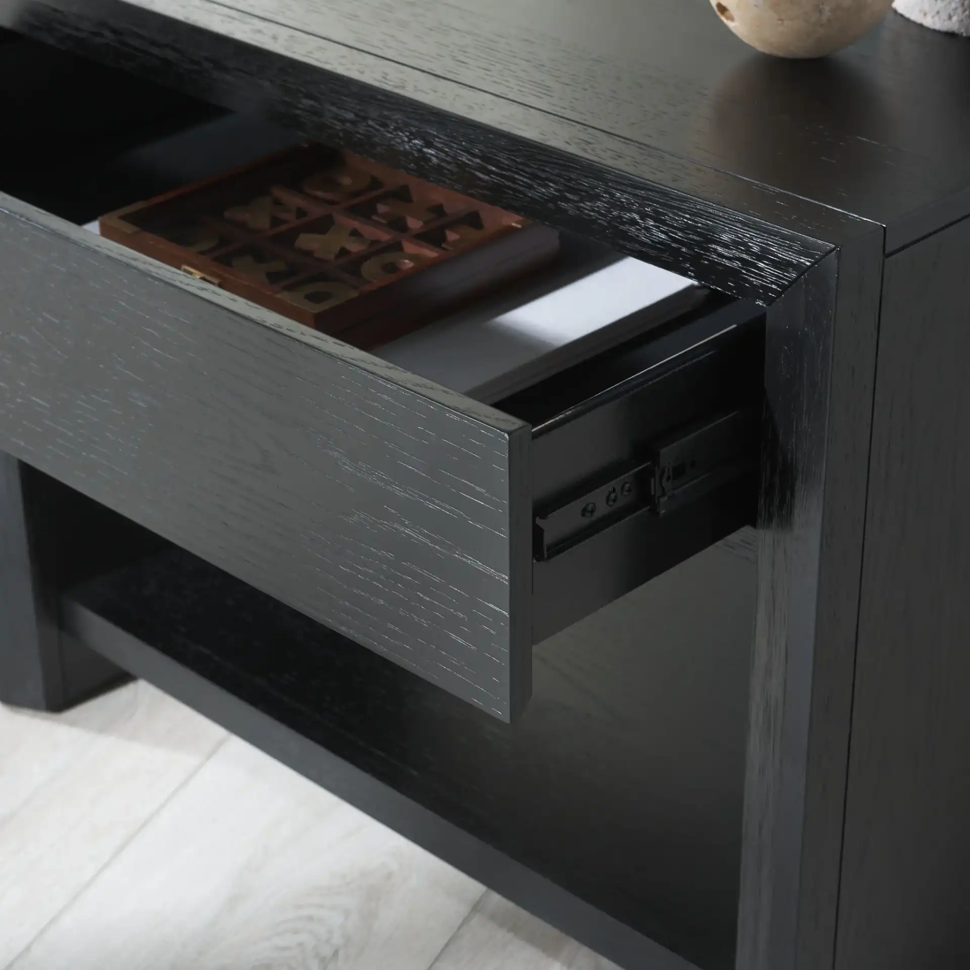 Darnell One-Drawer Nightstand in Black in a styled room