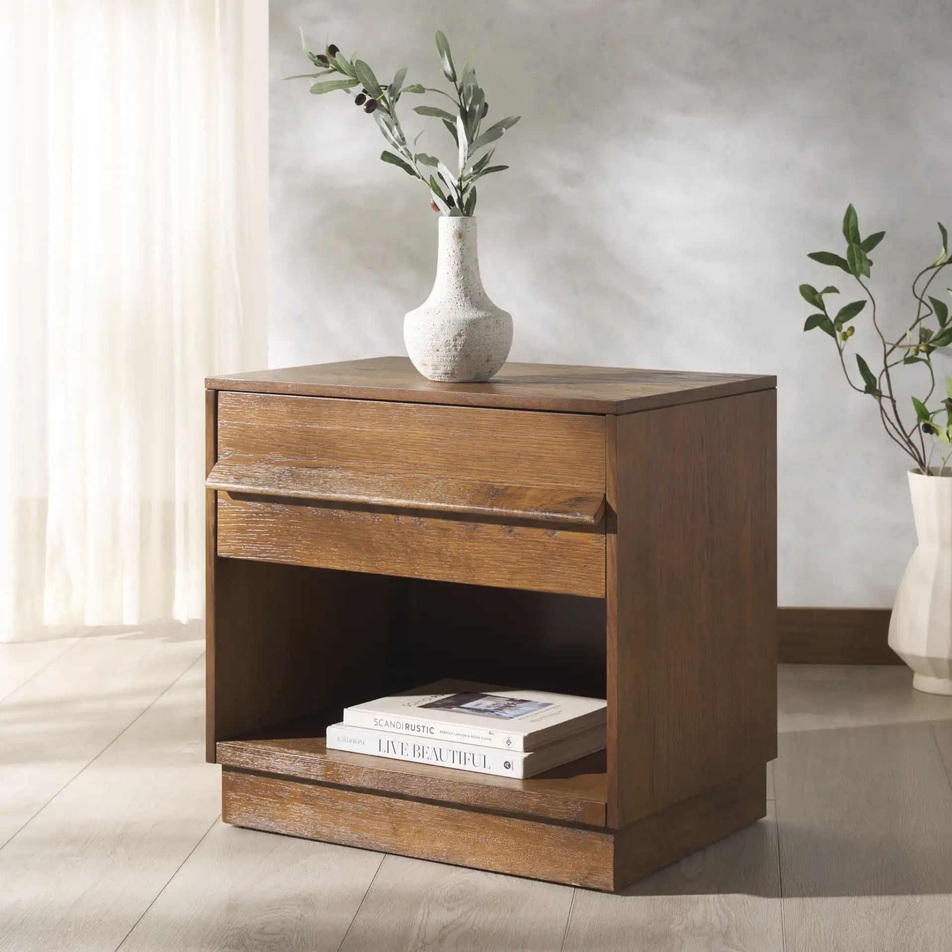 Deirdra One-Drawer Nightstand in Black in a styled room