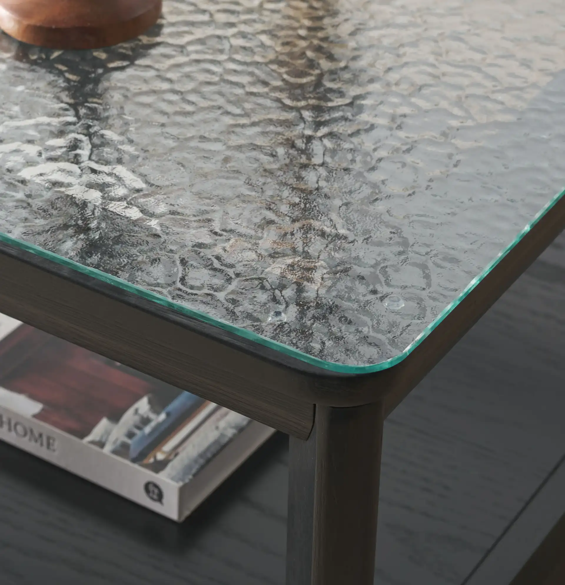 Benecarlo Glass Top Coffee Table in Black / Clear in a styled room