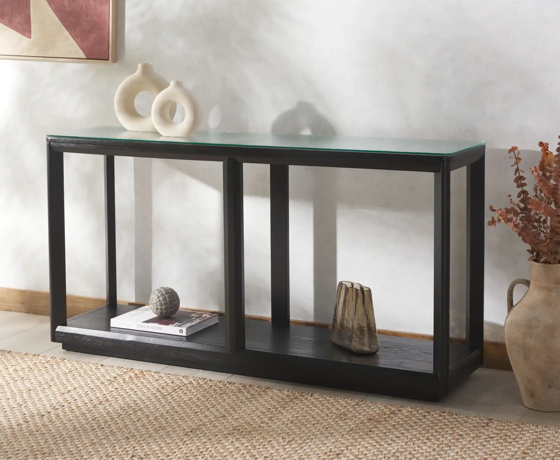 Benecarlo Glass Top Console Table in Black / Clear in a styled room