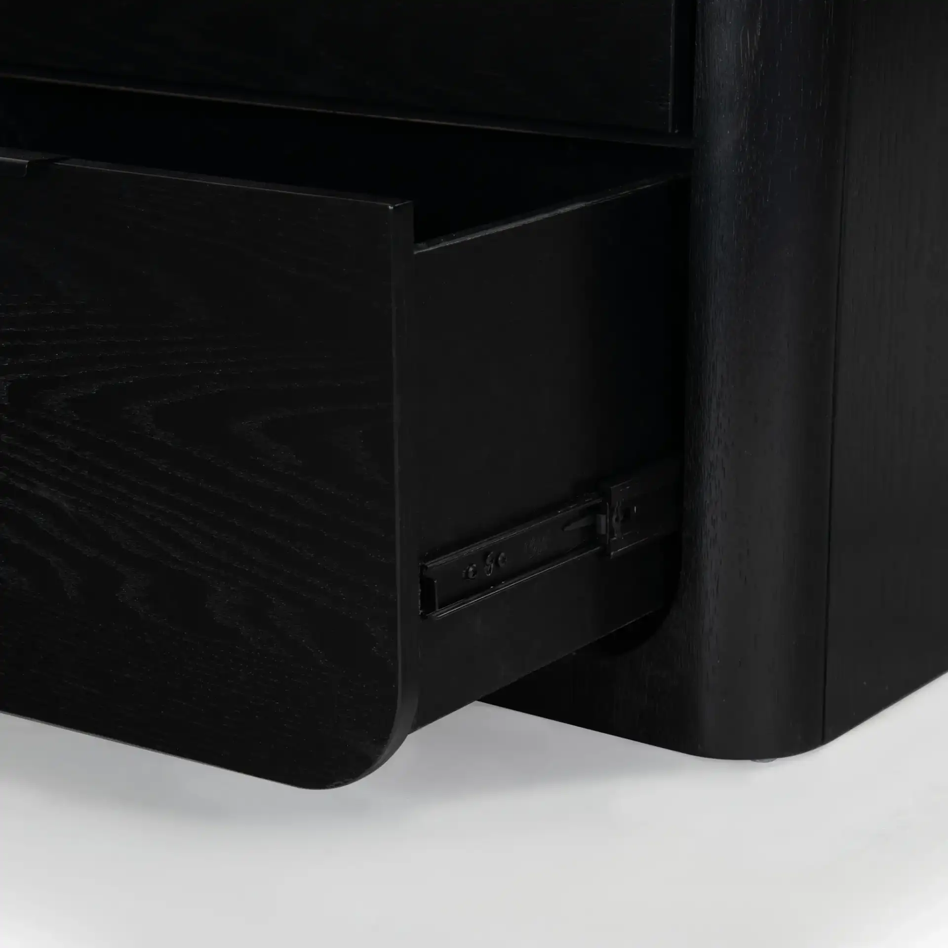 Raylie Two-Drawer Wood Nightstand in Black in a styled room