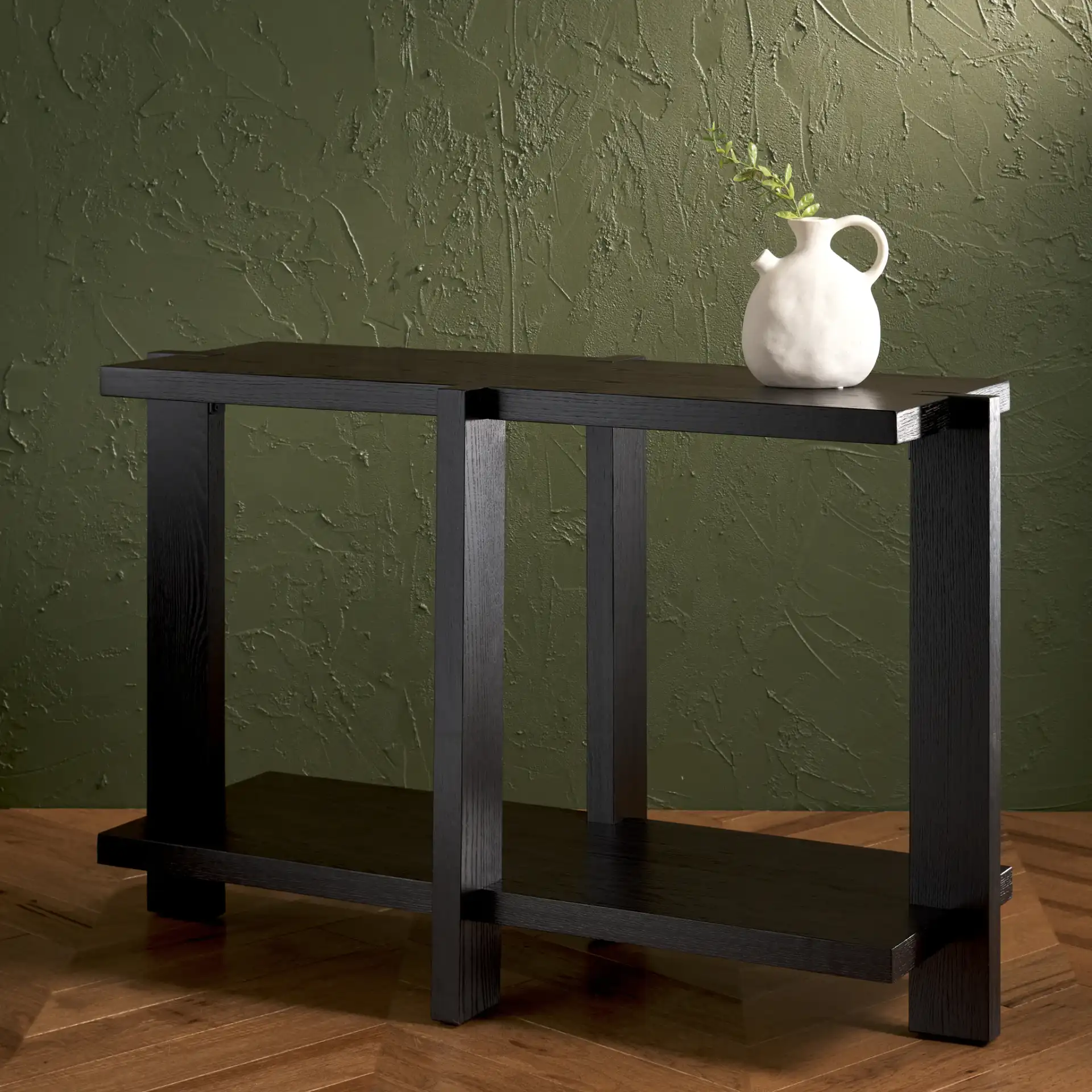 Quigley Rectangular Wood Console Table in Black in a styled room