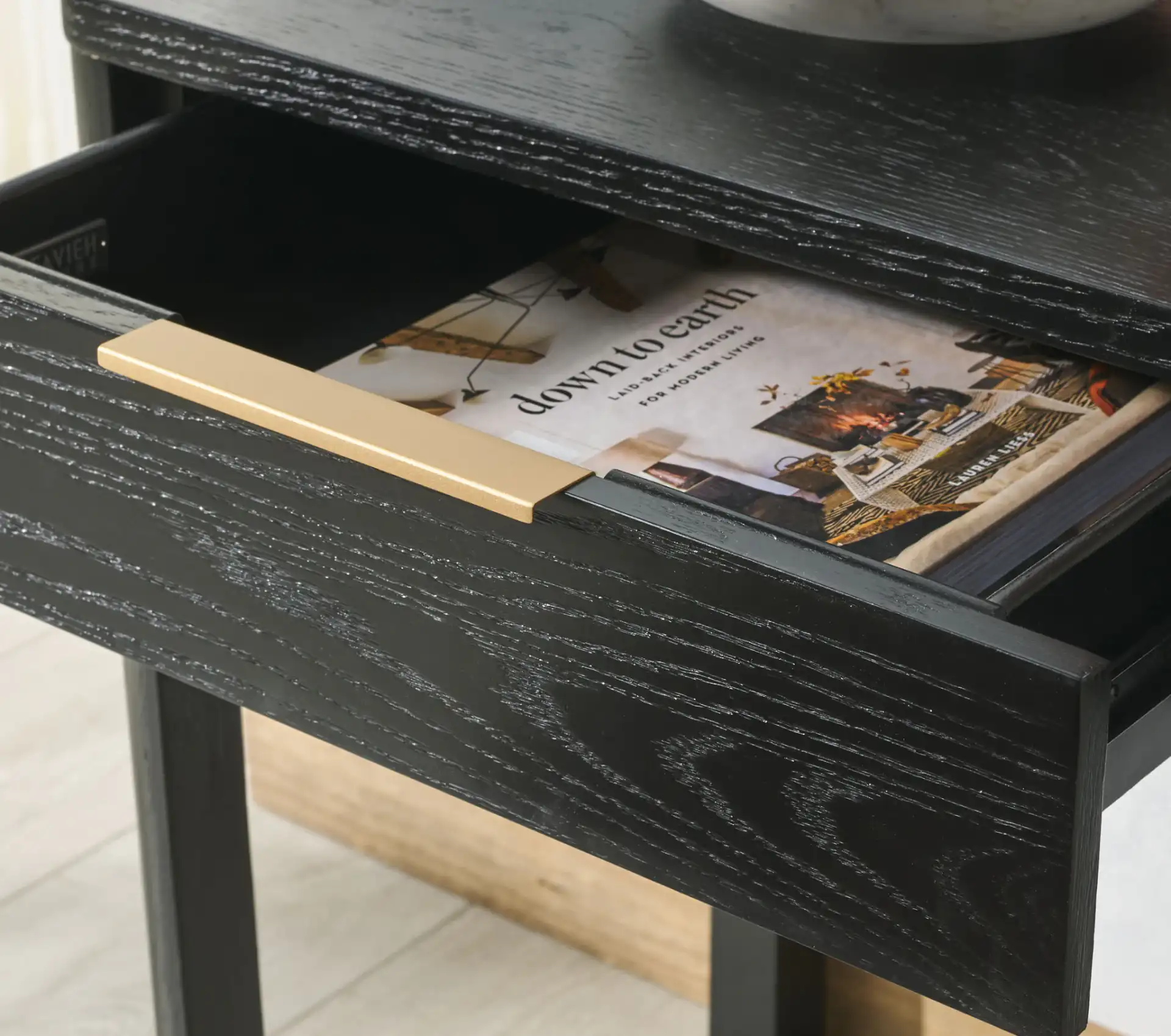 Gabrietta Two-Drawer Wood Desk in Black / Gold in a styled room