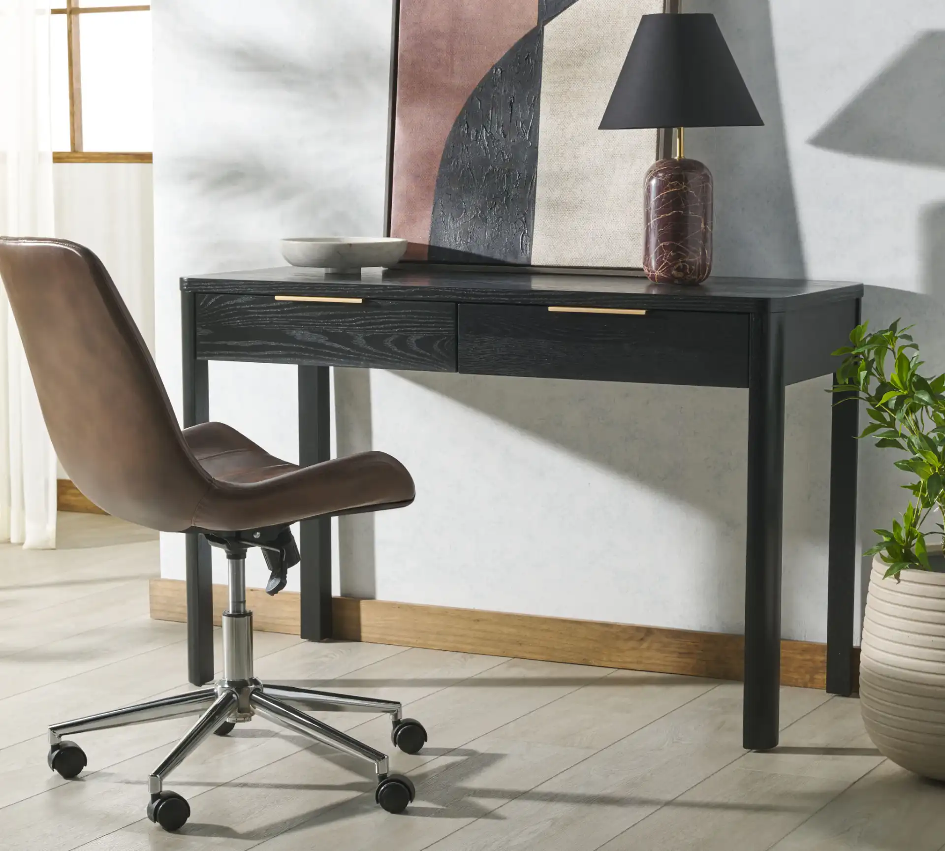Gabrietta Two-Drawer Wood Desk in Black / Gold in a styled room