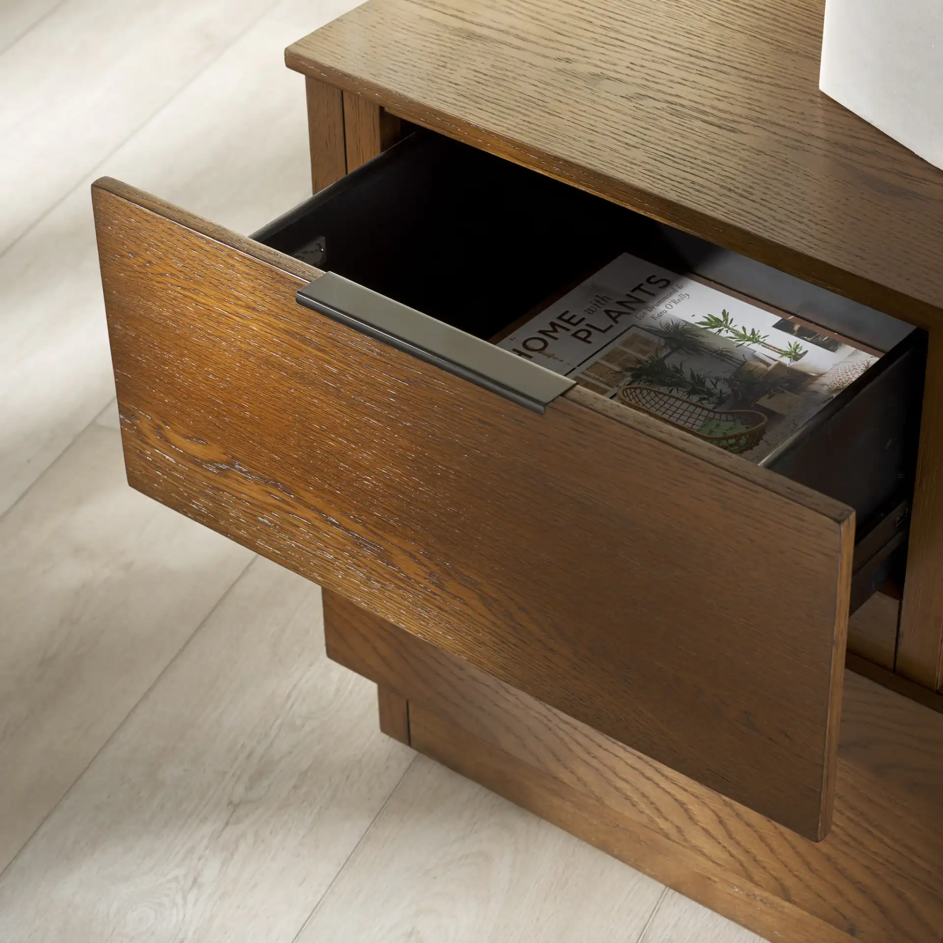Titus Two-Drawer Nightstand in Medium Oak in a styled room