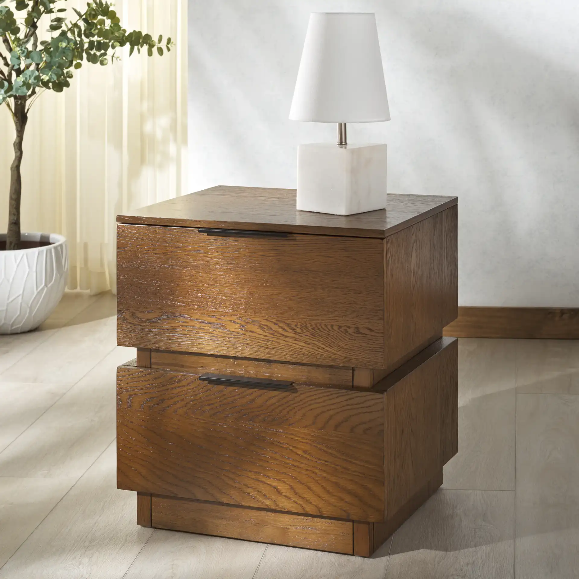 Titus Two-Drawer Nightstand in Medium Oak in a styled room