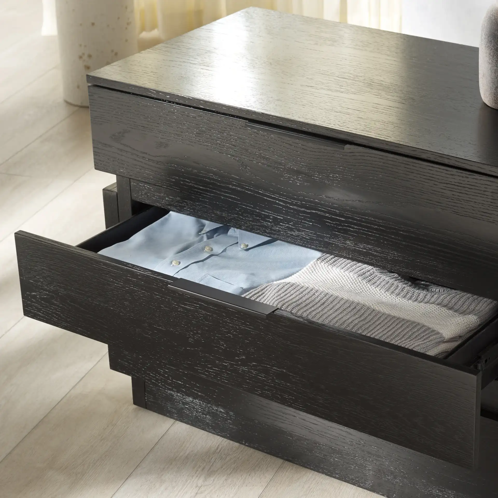 Titus Three-Drawer Stacked Chest in Black in a styled room