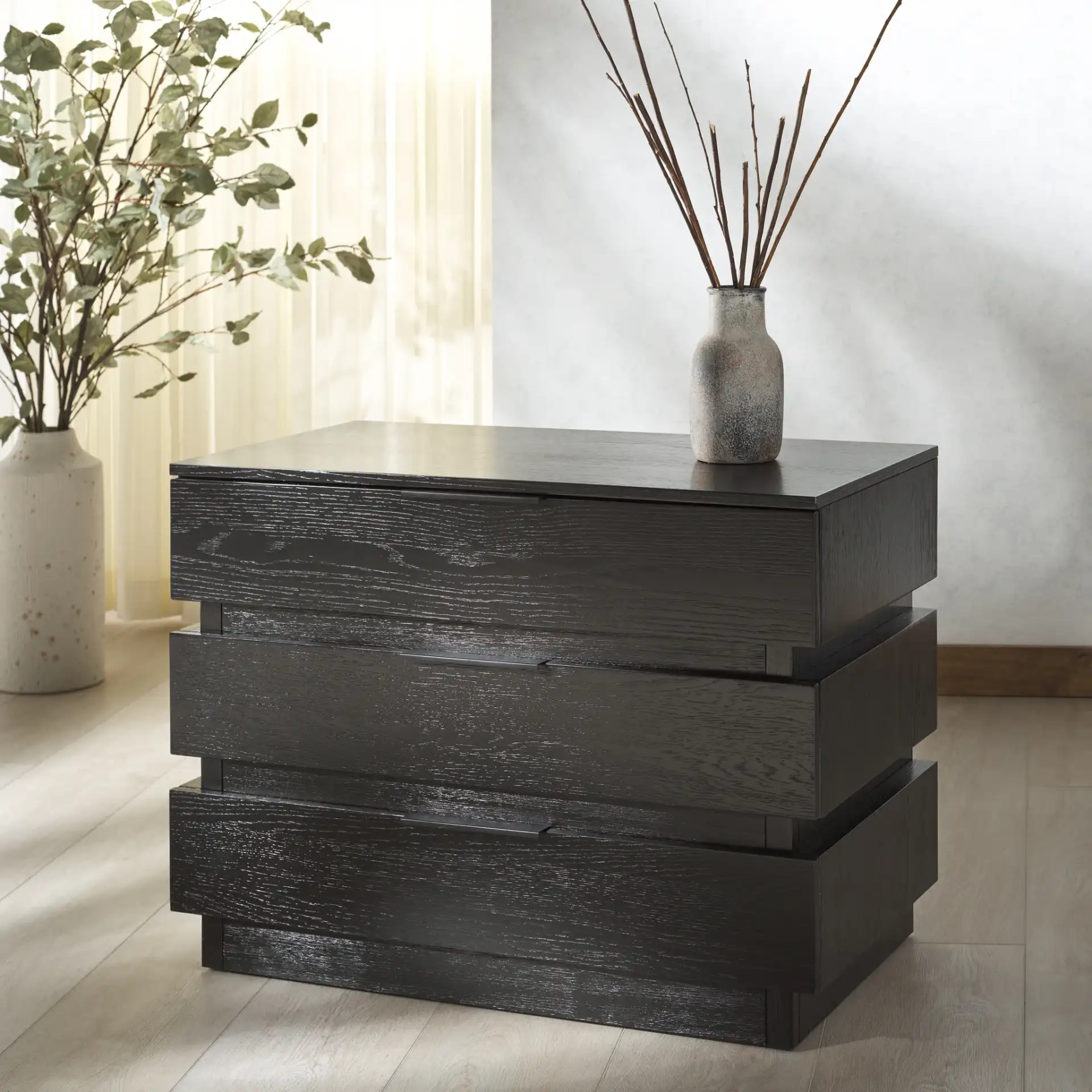 Titus Three-Drawer Stacked Chest in Black in a styled room