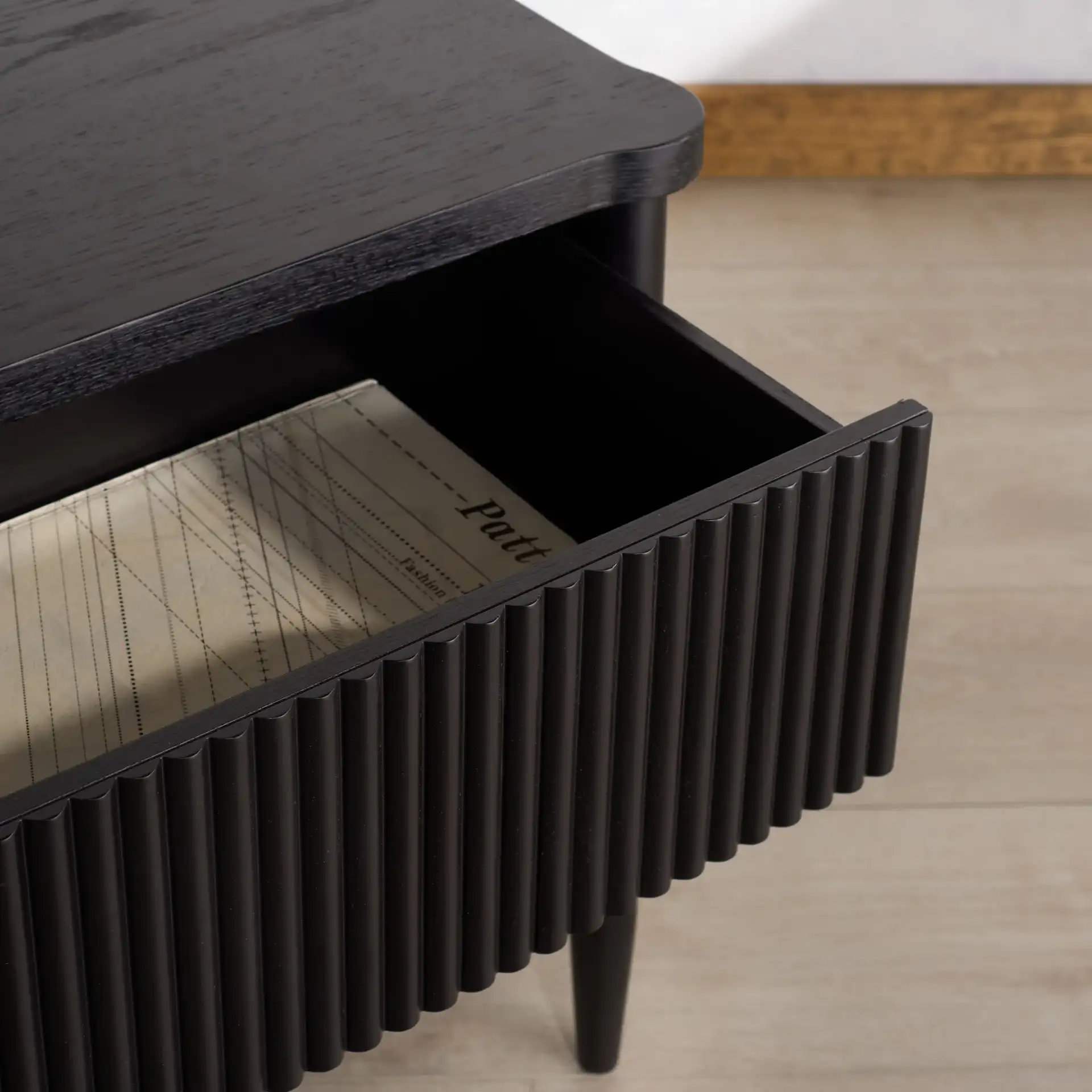 Shelbie One-Drawer Nightstand in Black in a styled room
