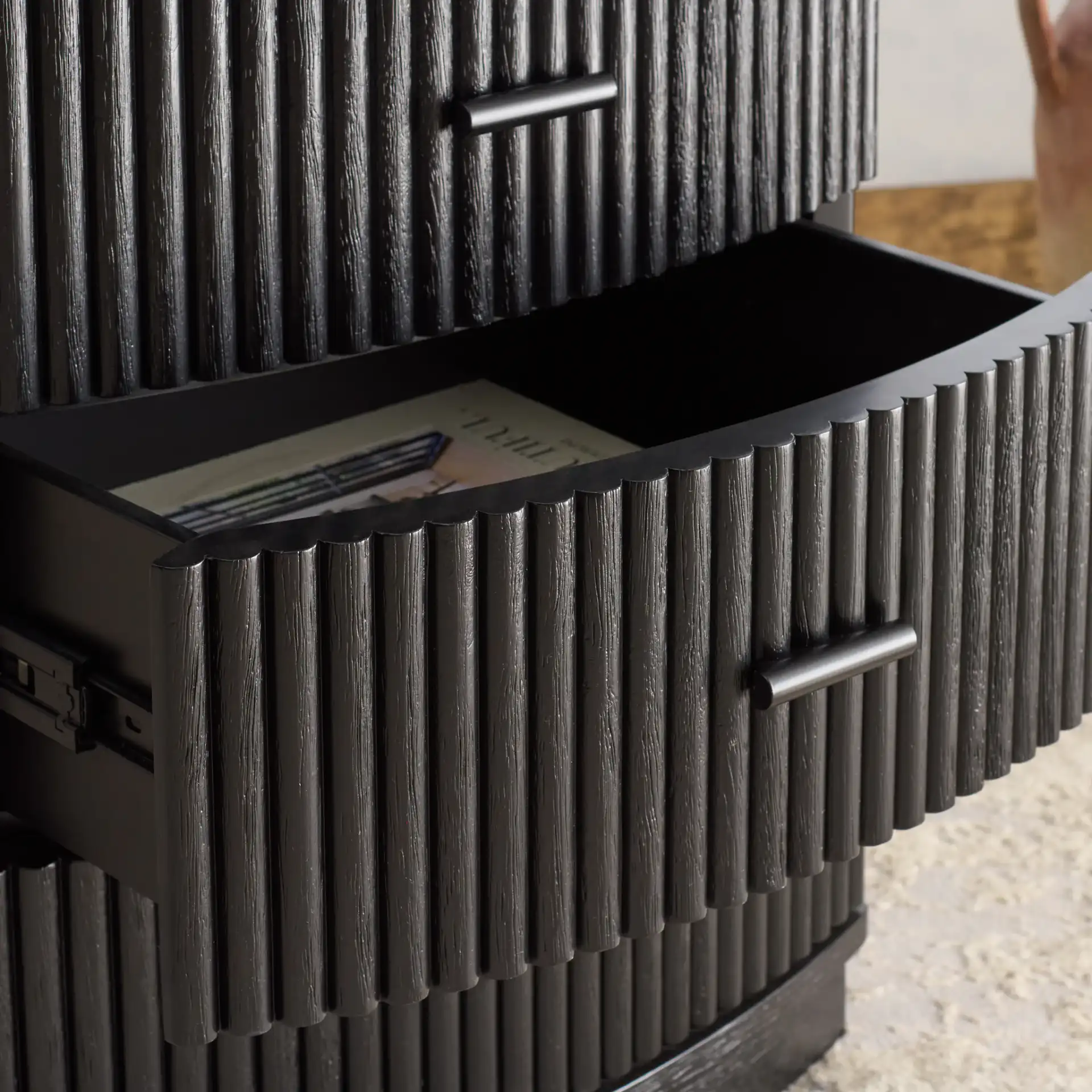 Shelbie Three-Drawer Nightstand in Black in a styled room
