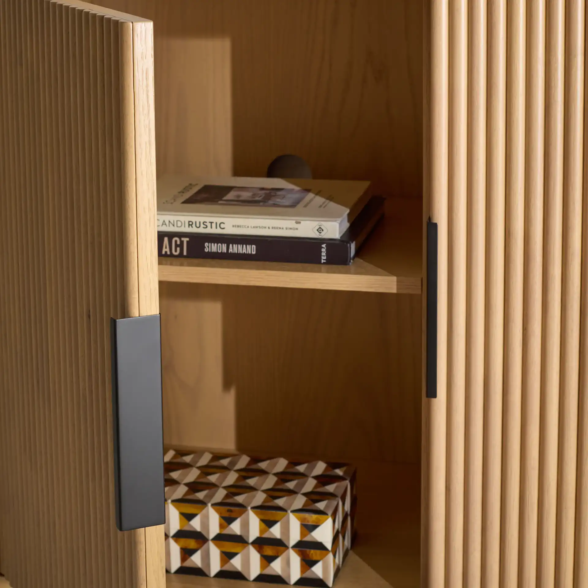 Shelbie Three-Door Reeded Sideboard in Oak / Black in a styled room