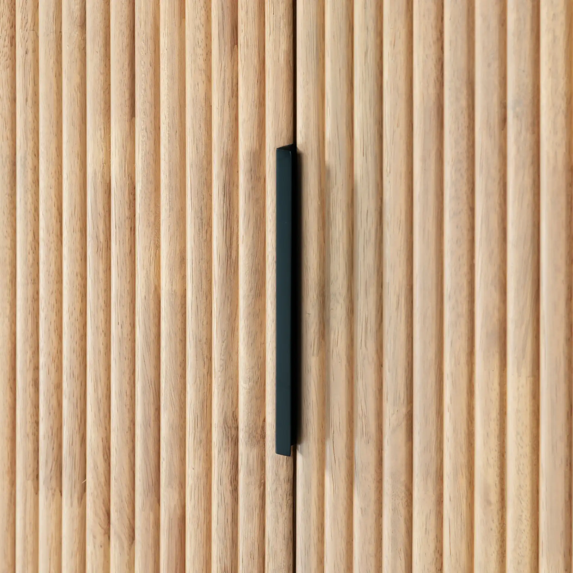 Shelbie Three-Door Reeded Sideboard in Oak / Black in a styled room