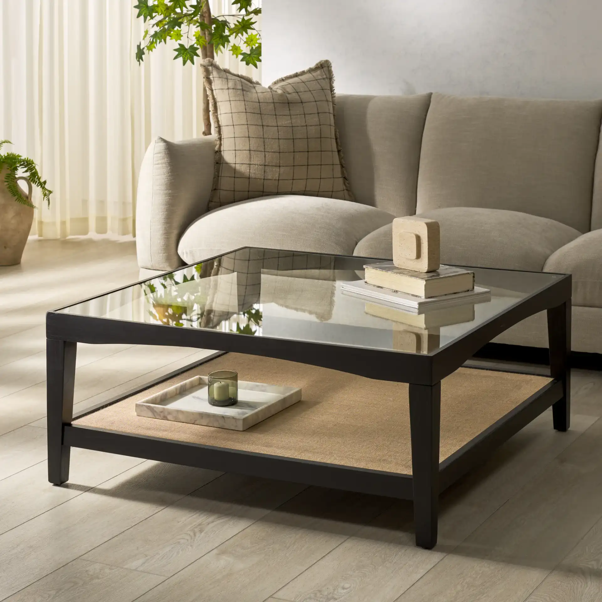 Nicolella Square Glass Coffee Table in Black in a styled room