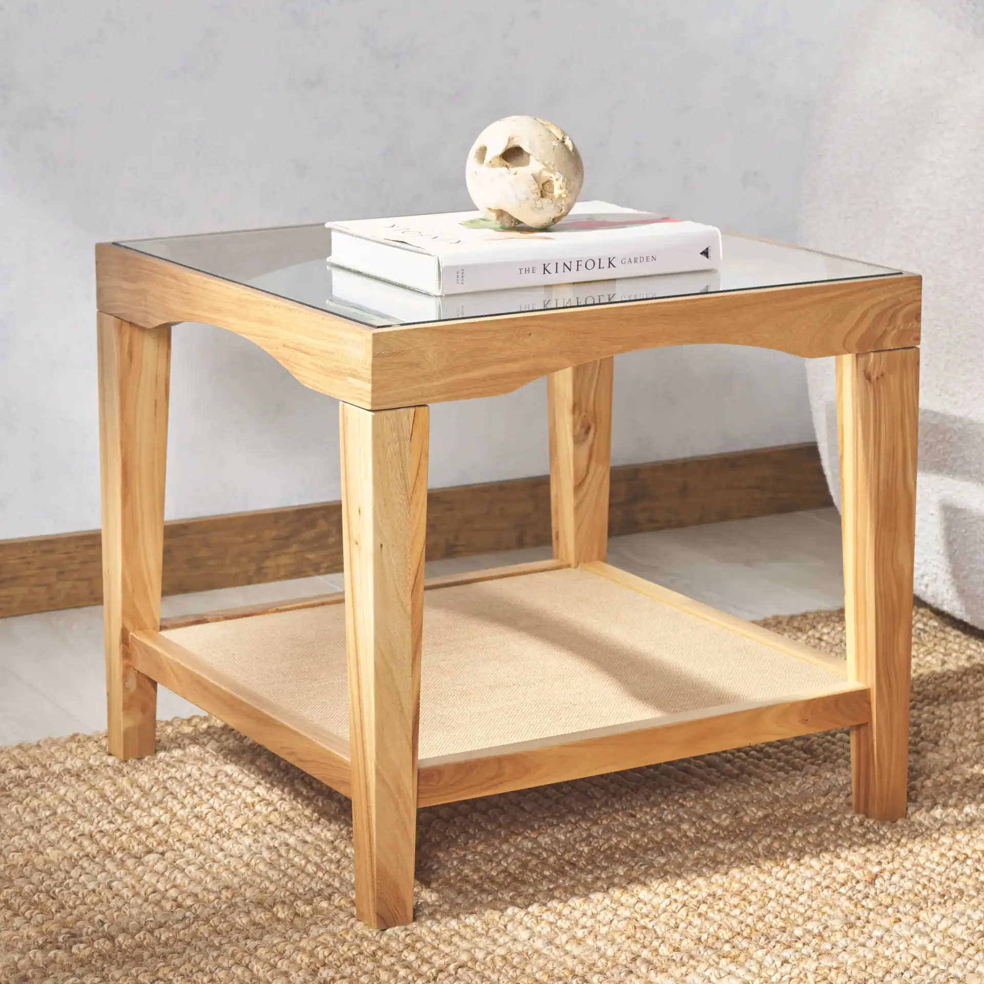 Nicolella Square Glass Accent Table in Black in a styled room