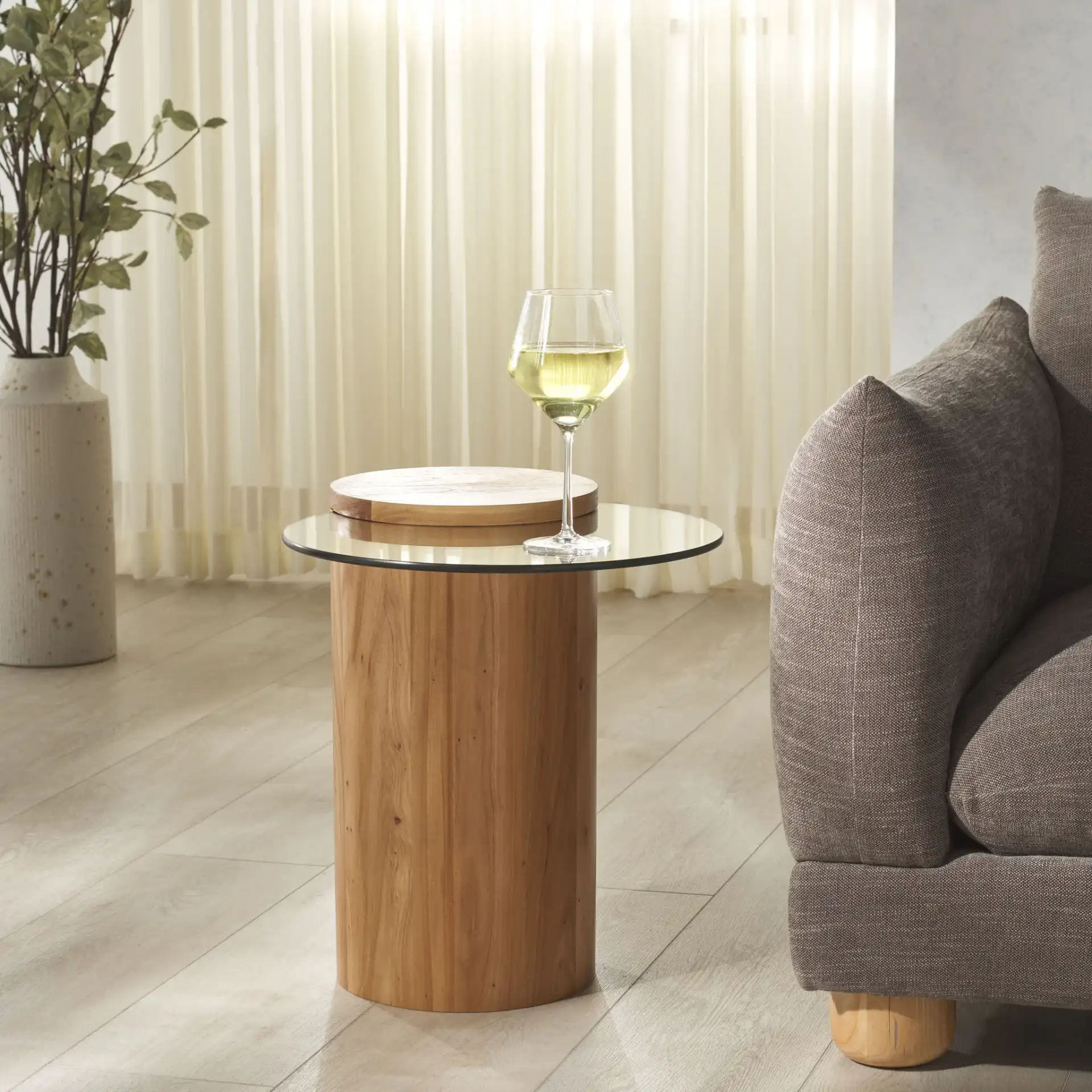 Tasharose Wood And Glass Accent Table in Natural / Clear in a styled room