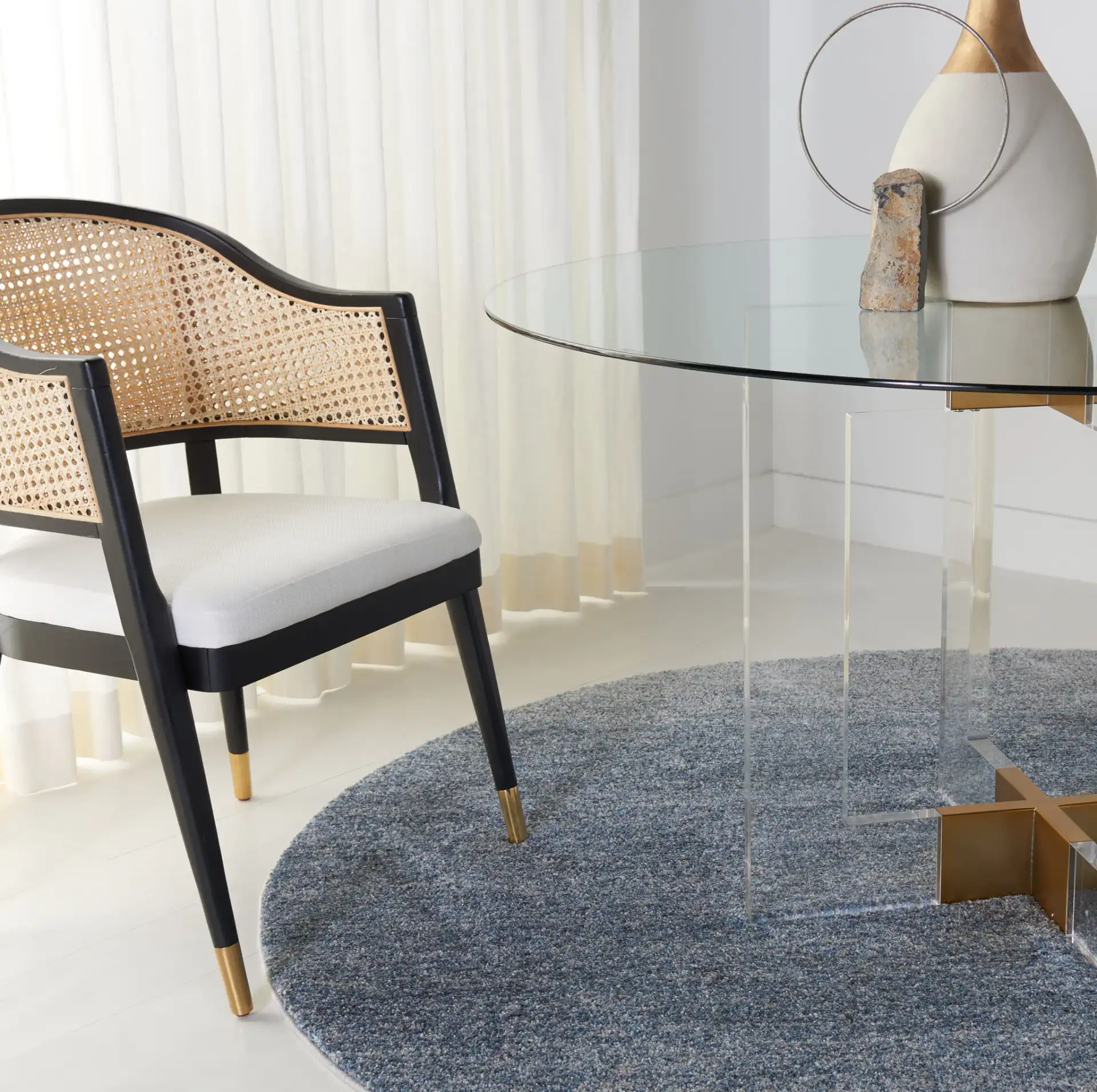 Xevera Acrylic Round Dining Table in Gold / Clear in a styled room