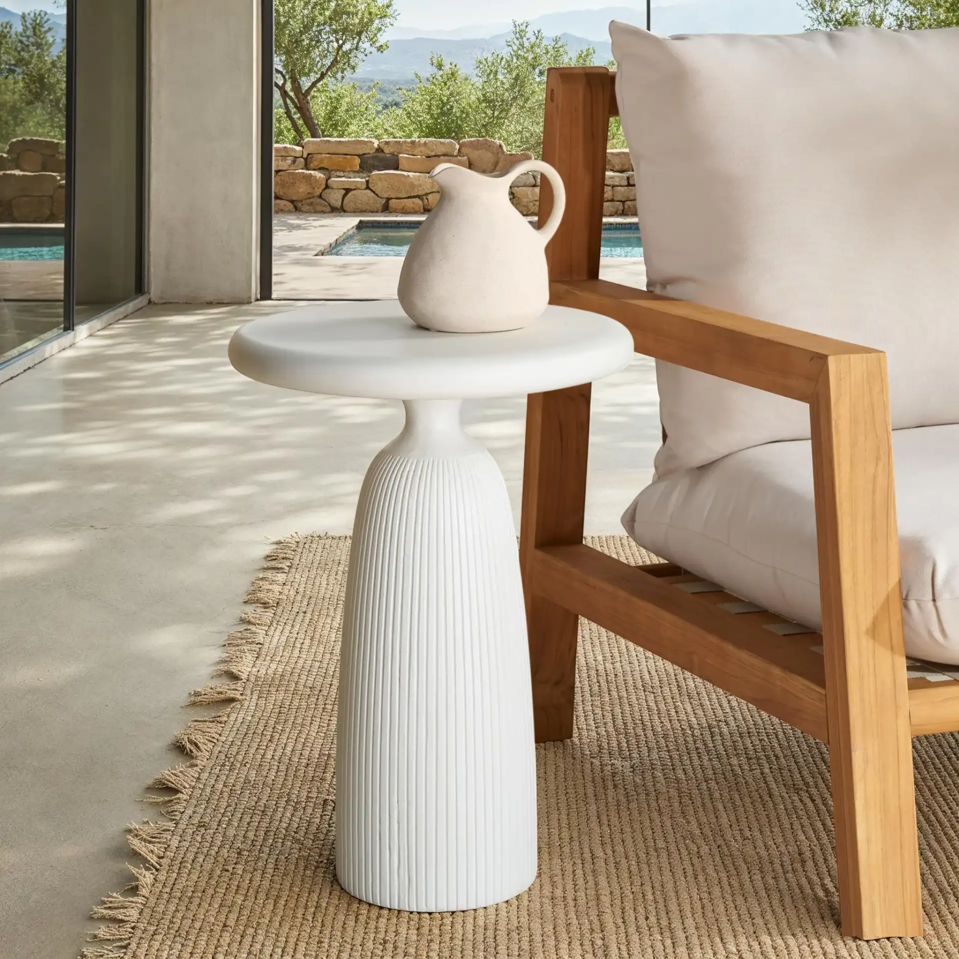 Oskar Round Concrete Accent Table in Brown in a styled room