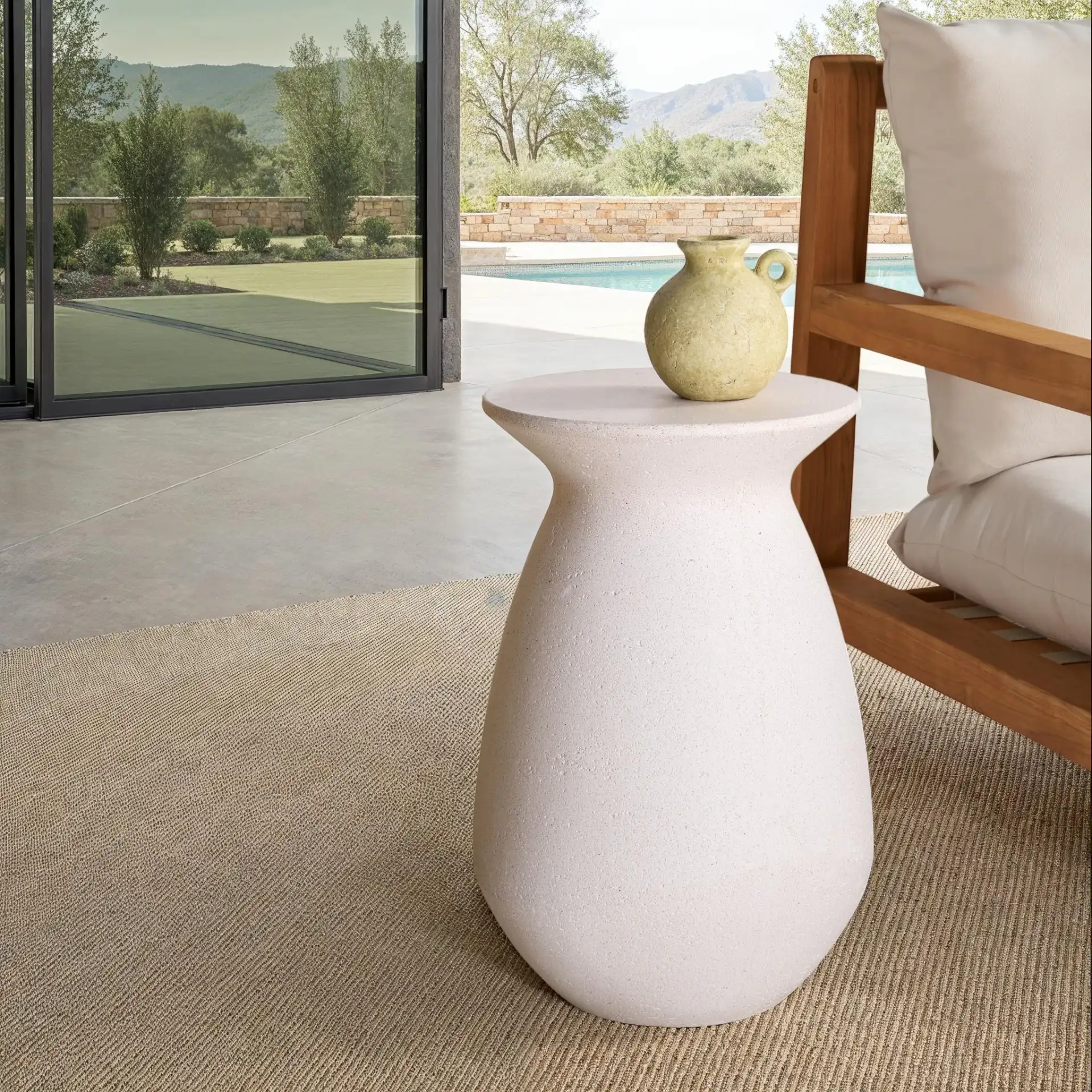 Dynah Concrete Accent Table in Ivory in a styled room