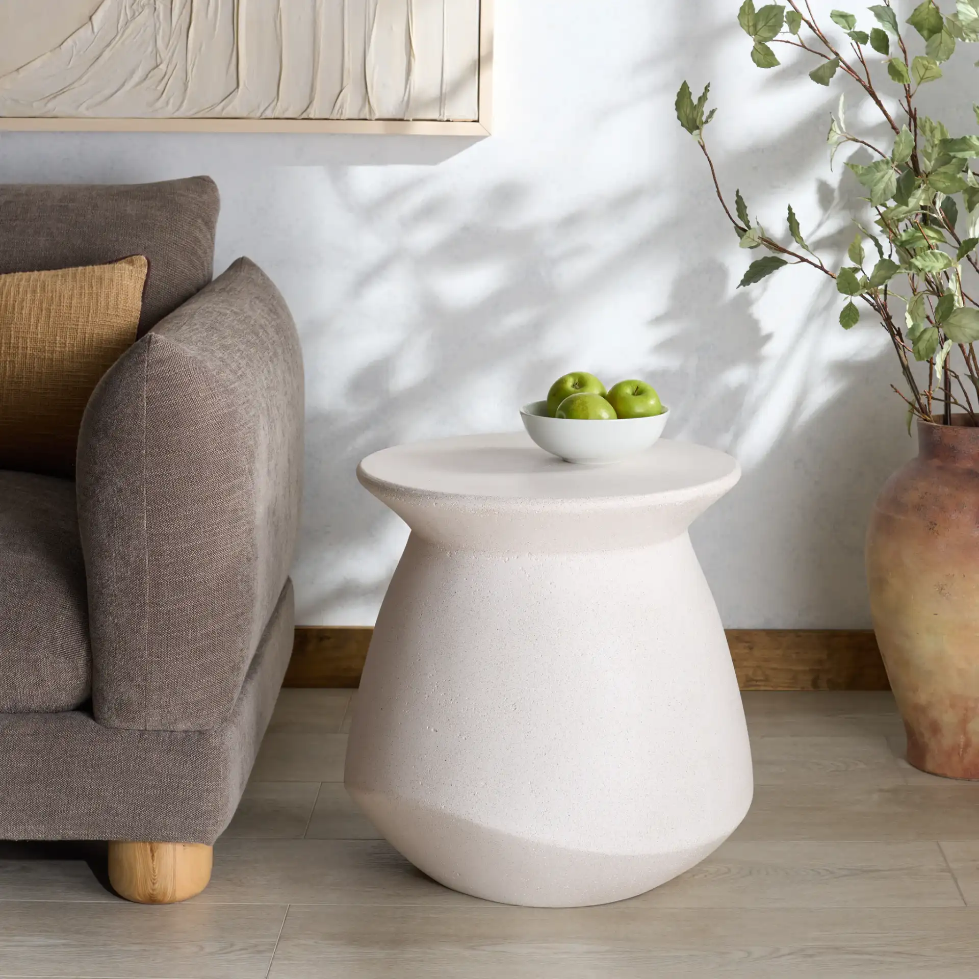 Flanagan Round Accent Table in Ivory in a styled room