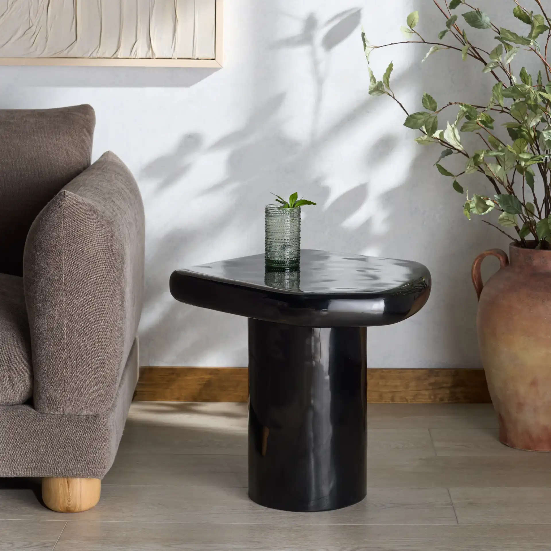Rhianna Concrete Accent Table in Black in a styled room