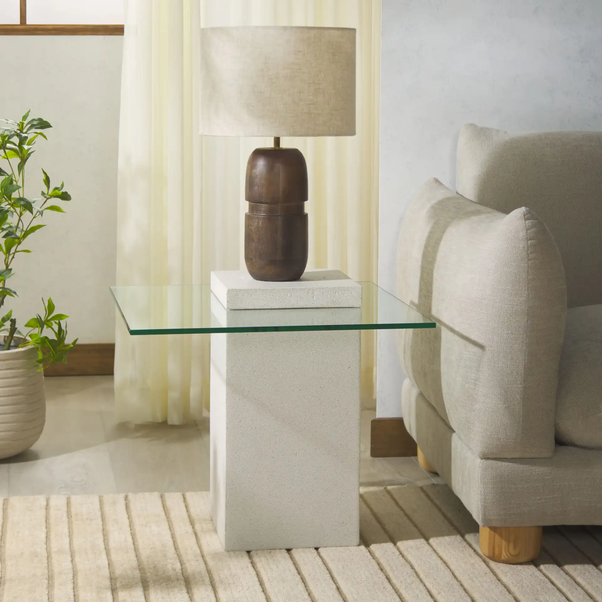 Sophibeth Concrete Accent Table in Ivory / Clear in a styled room