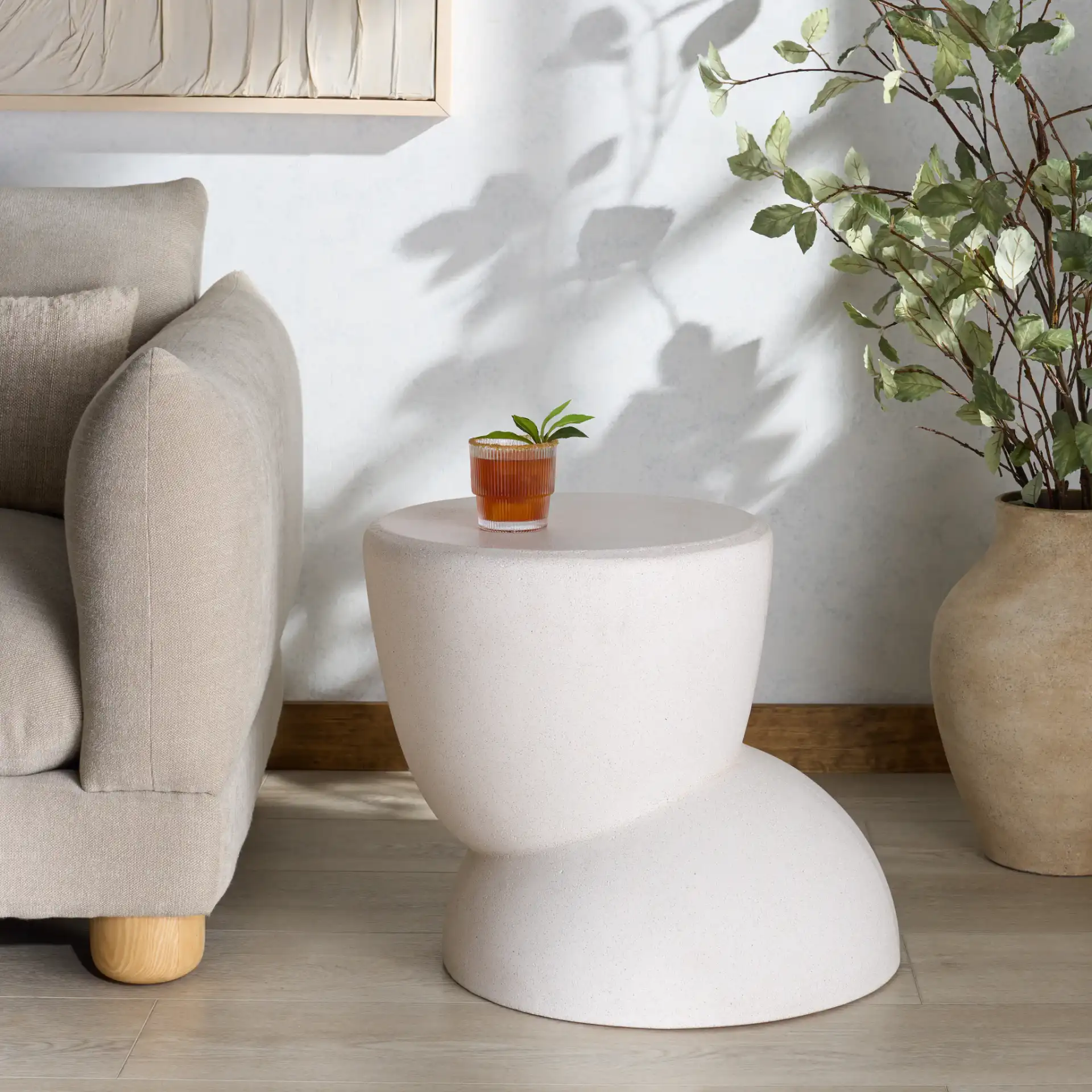Glynda Concrete Accent Table in Ivory in a styled room