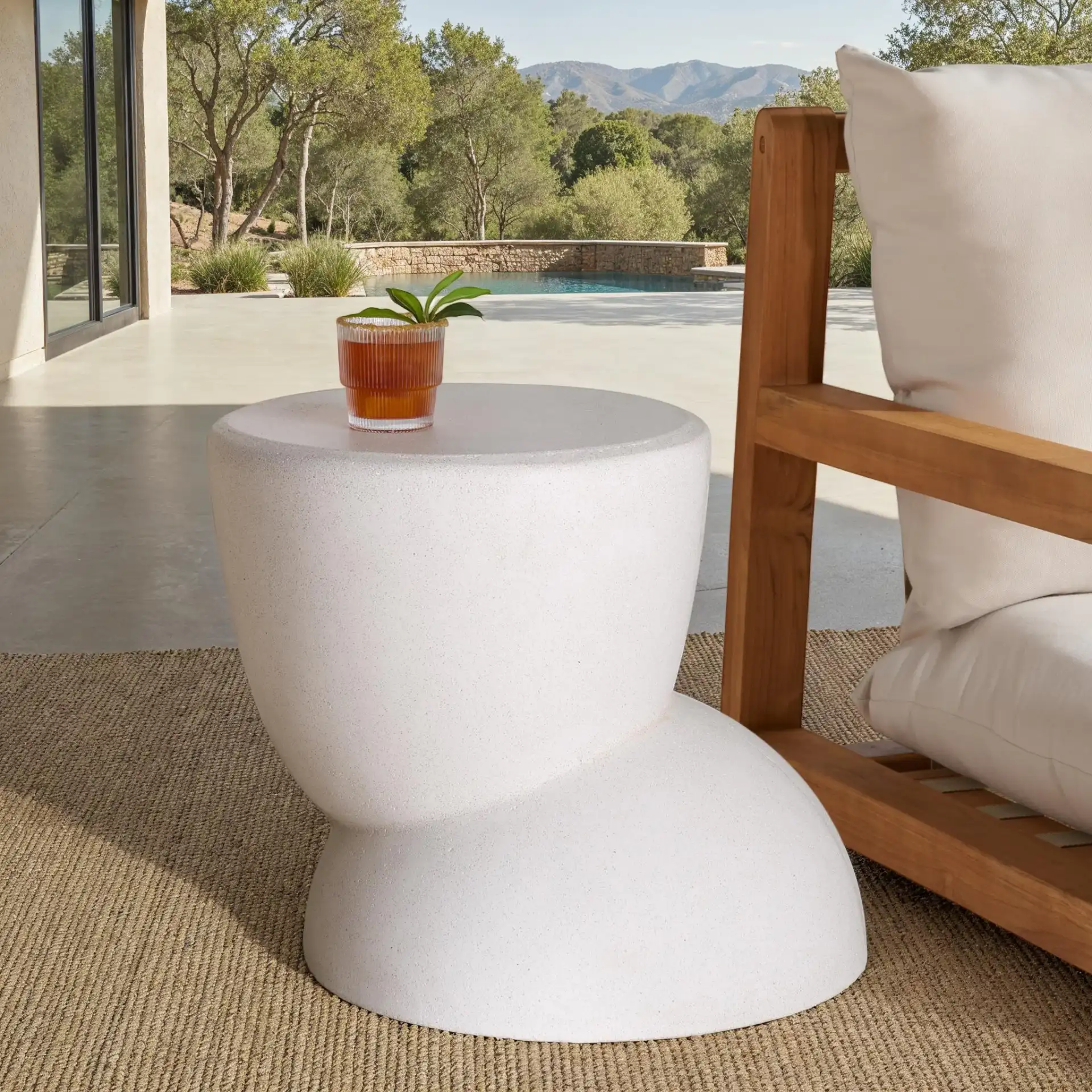 Glynda Concrete Accent Table in Ivory in a styled room