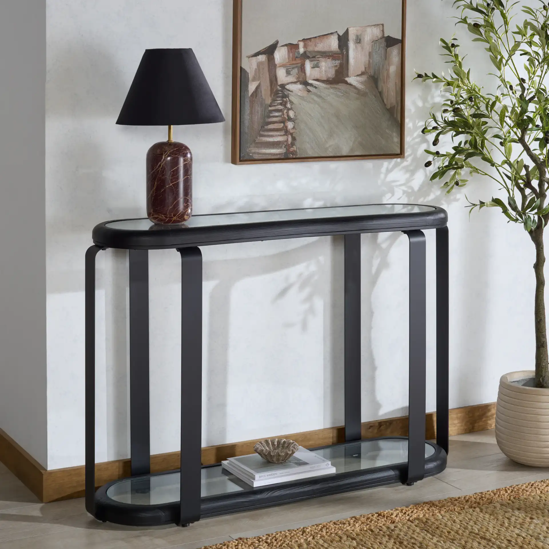 Tyrese Metal Console Table in Black / Clear in a styled room
