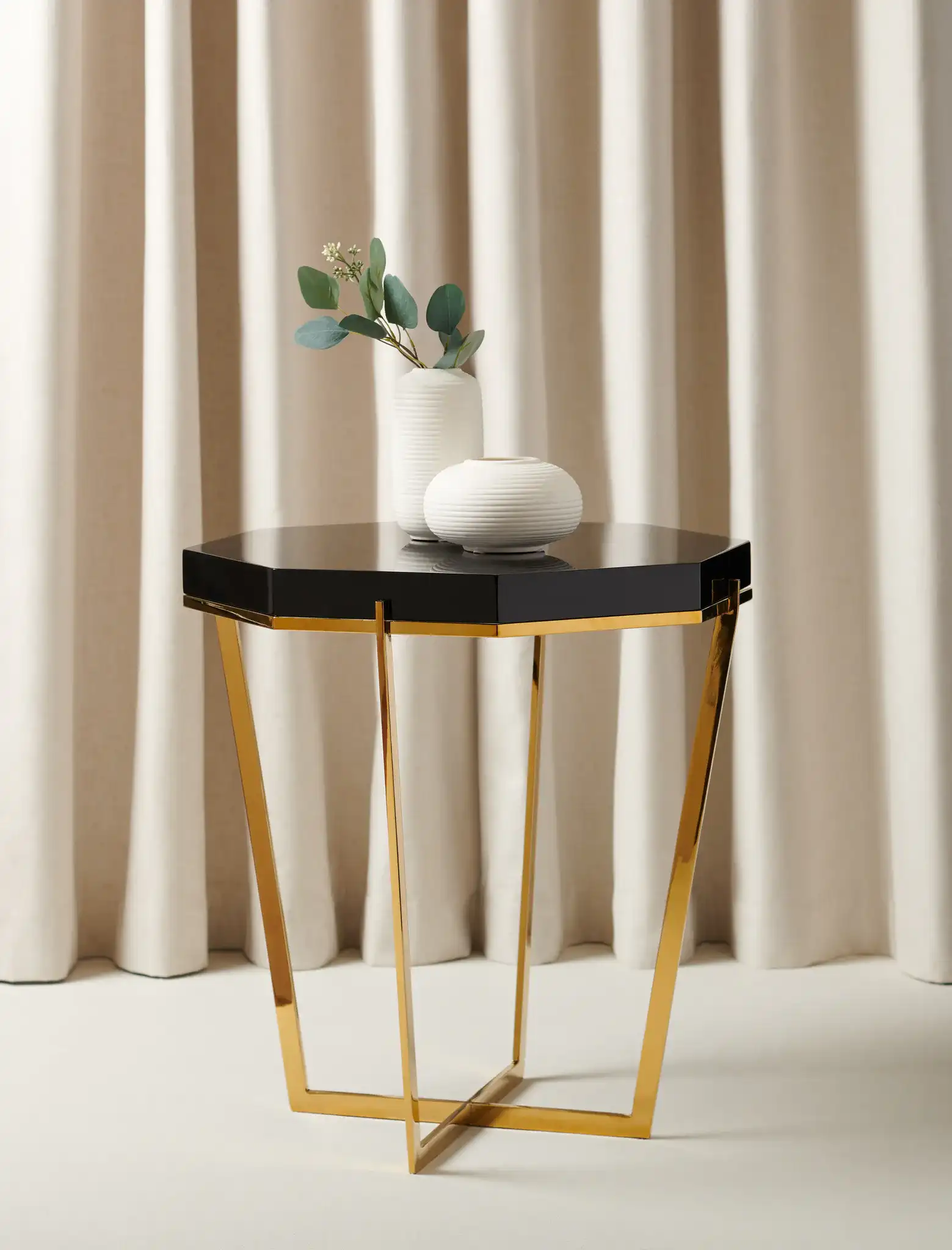 Danna End Table in Gold / Black in a styled room