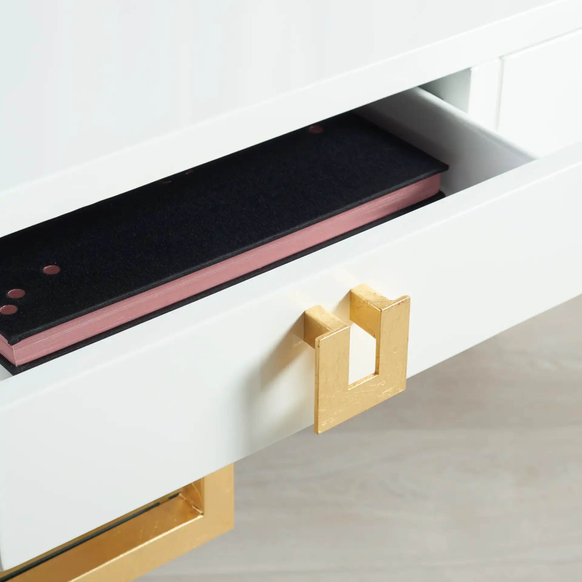 Neria Writing Desk in White / Gold in a styled room