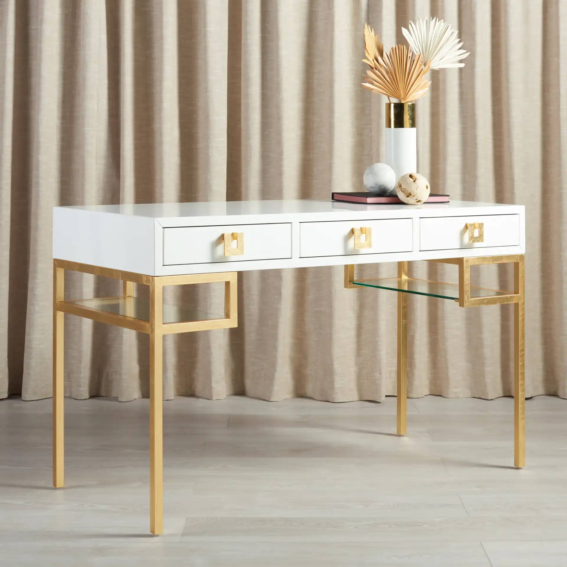 Neria Writing Desk in White / Gold in a styled room